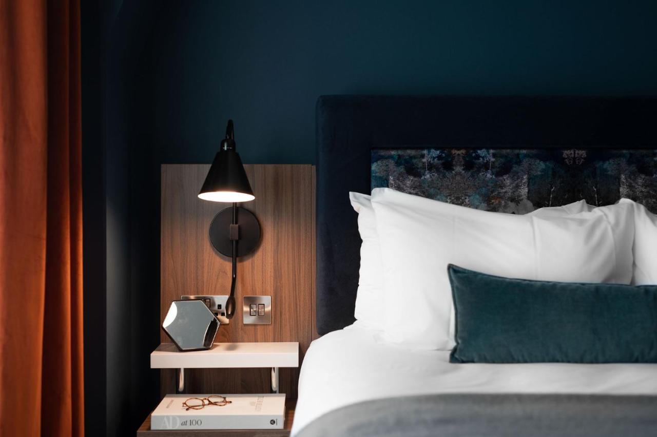 Modern hotel room with bedside power outlets, ideal for business travel and corporate events.