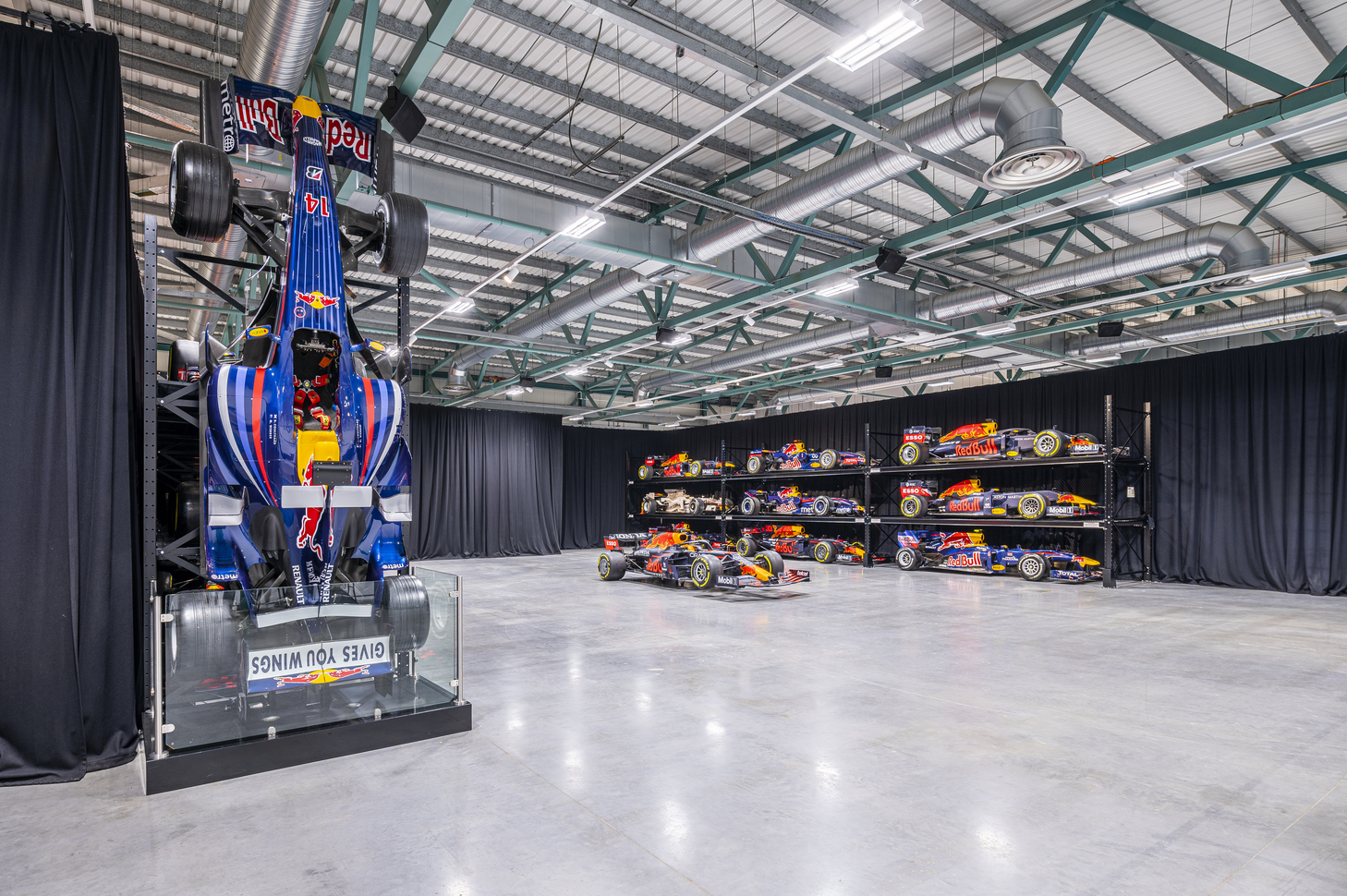 MK-7 Warehouse at Red Bull Racing with racing car display, ideal for corporate events.