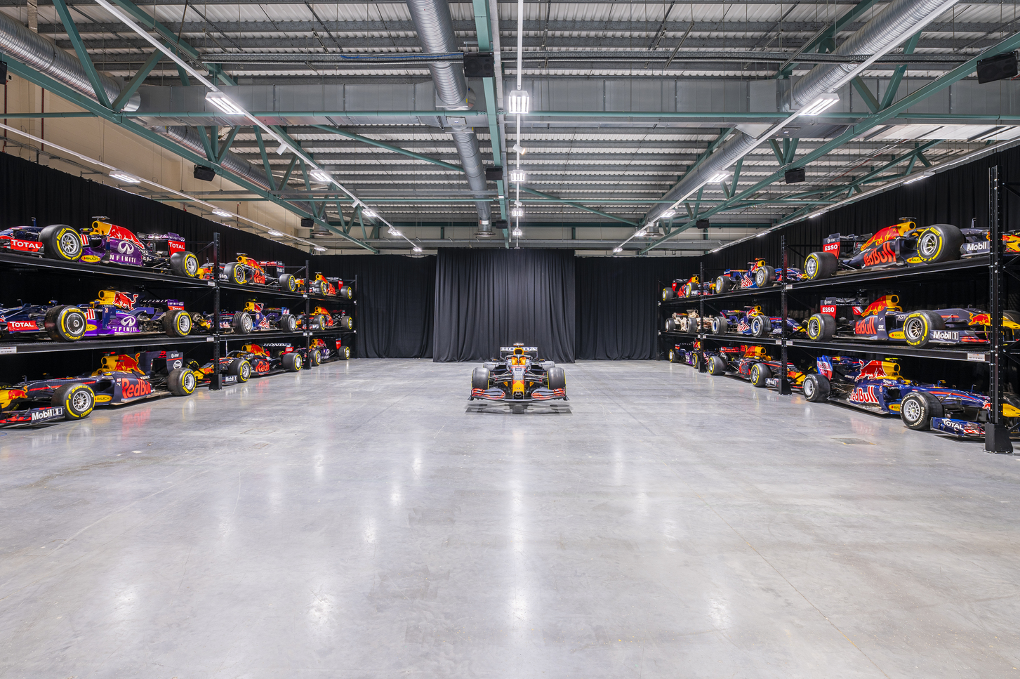 MK-7 Warehouse venue with Formula 1 cars, ideal for corporate events and product launches.