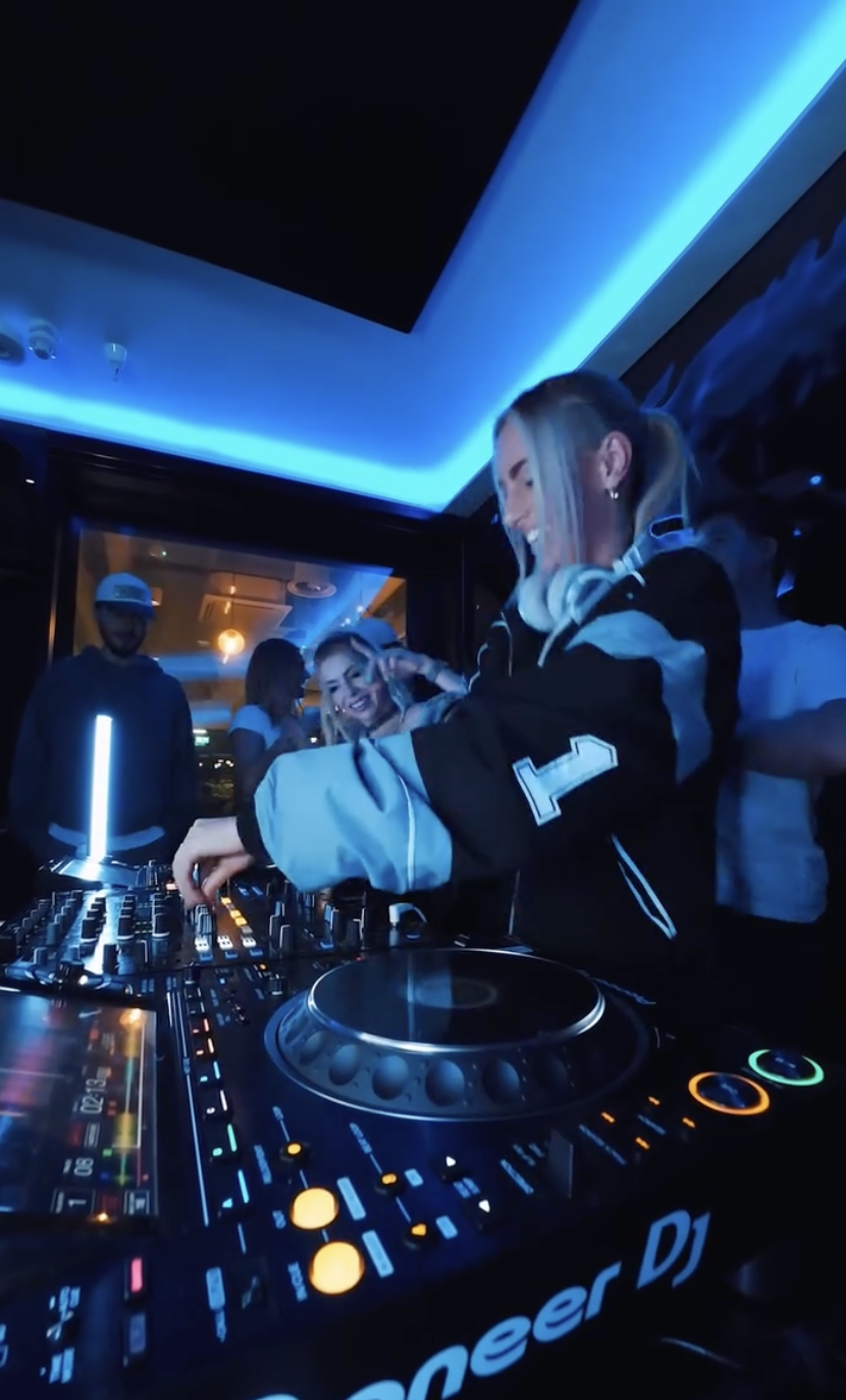 "Vibrant DJ setup with dynamic lighting at Qube Elephant Lounge for networking events."