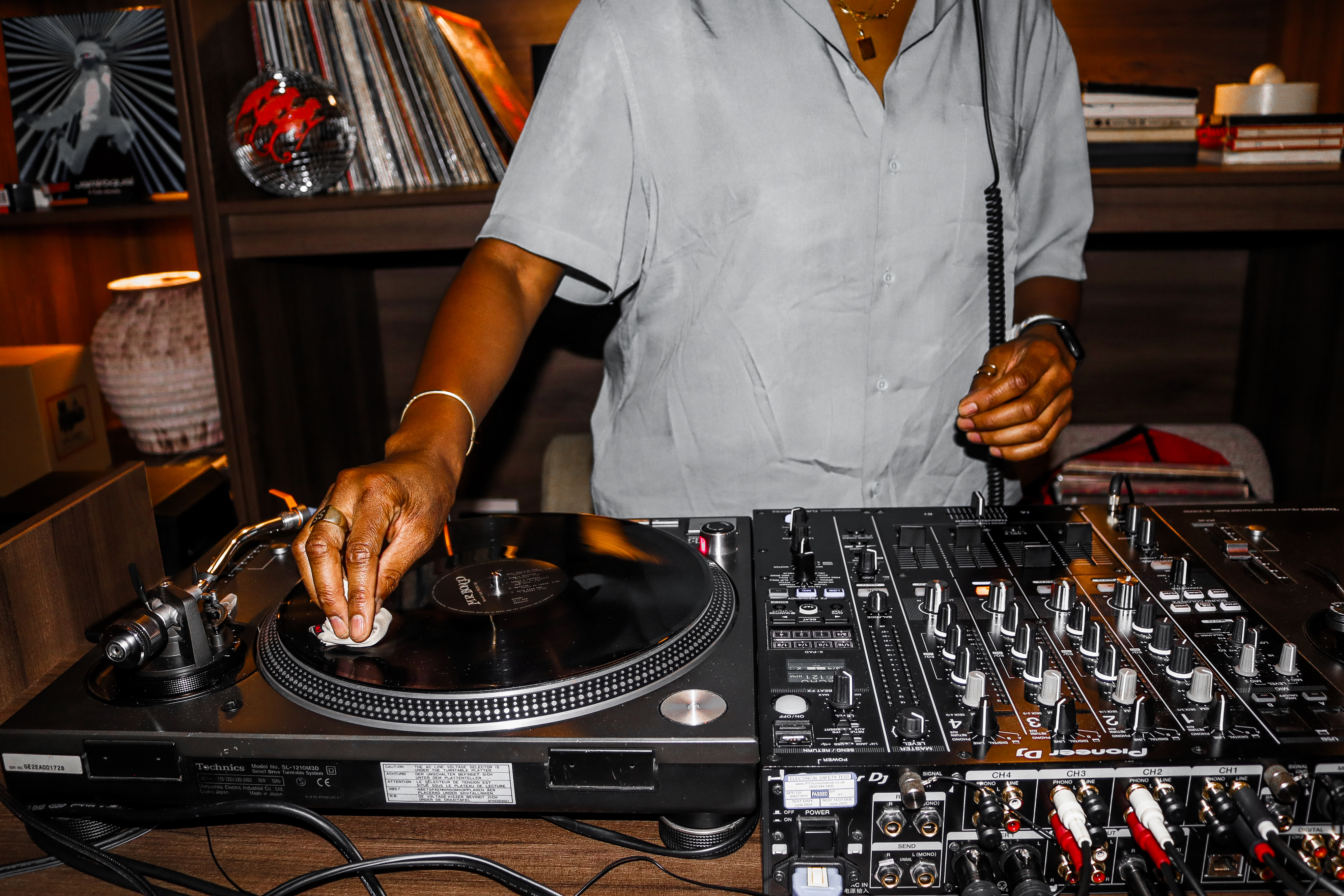 DJ setting up vinyl at Qube Elephant Lounge for memorable music events.