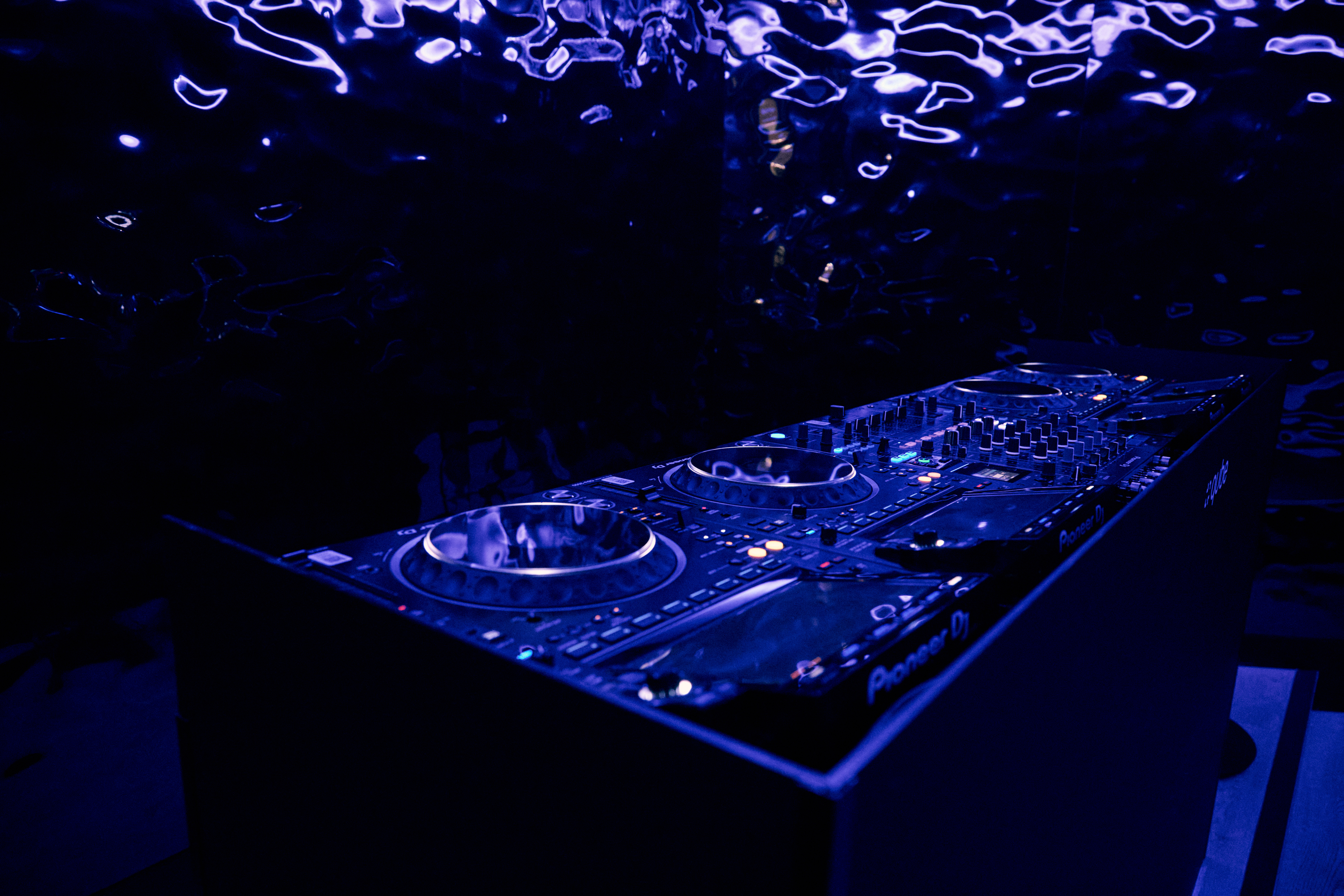 Sleek DJ setup with blue lighting at Qube Elephant Lounge for lively events