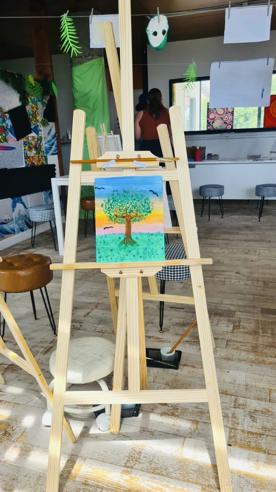 Artblast Studio: Paint and sip corporate team-building event with easels and modular seating.