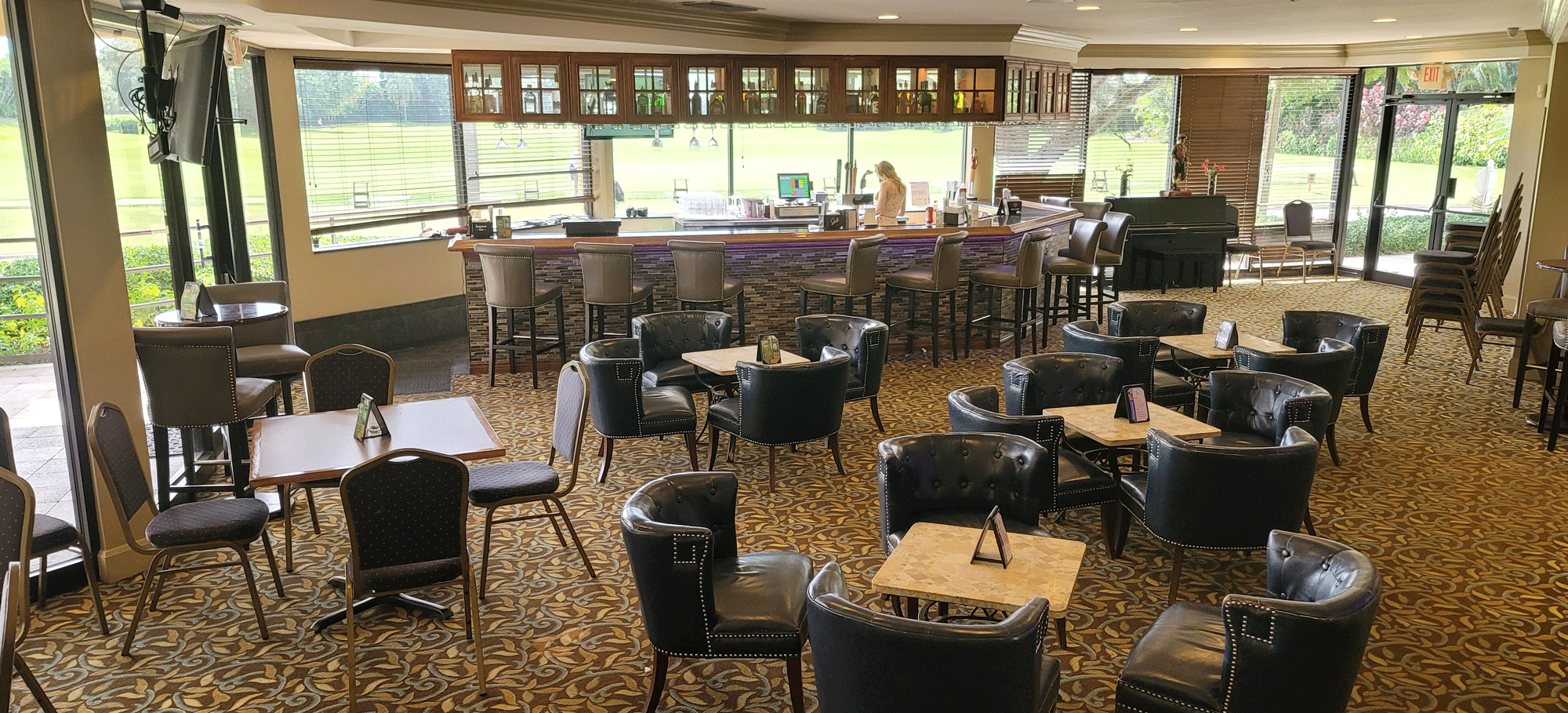 Clubhouse lounge with central bar for networking receptions and cocktail events.