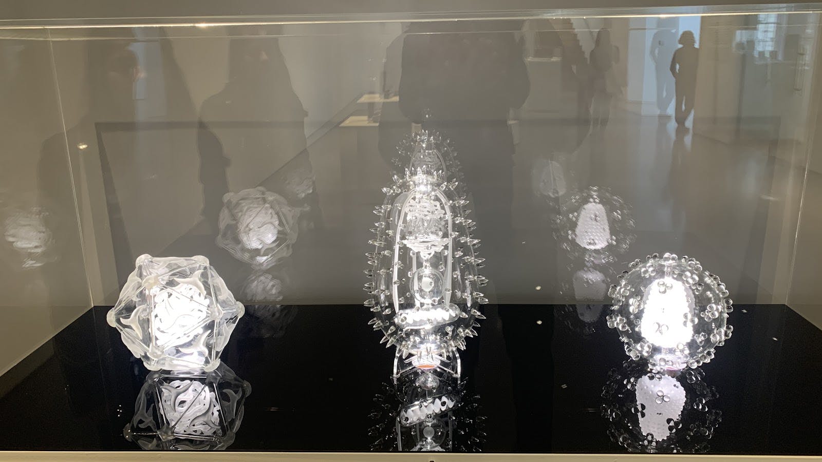 Glass vitrine centerpiece at Henry Moore Institute corporate exhibition.