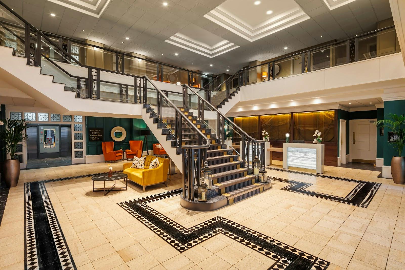 Crowne Plaza conference lobby with grand staircase for corporate events and registration venues.