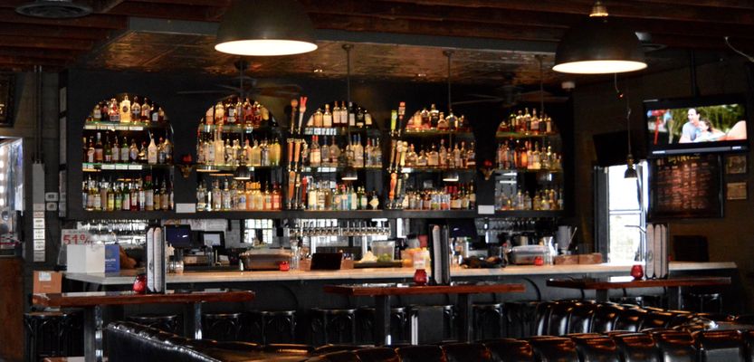 Gibson Street Bar with premium back-bar and booth seating for cocktail receptions or networking.