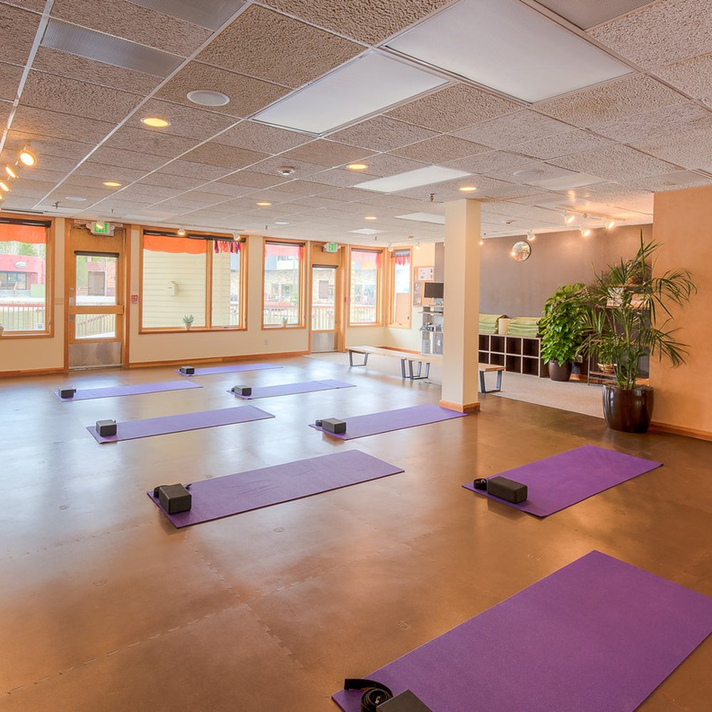 Yoga studio with natural light for team-building workshops and mindfulness sessions.