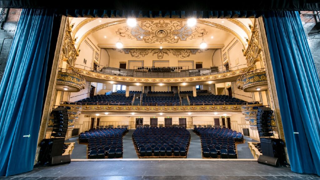 Lyric Theatre proscenium stage with tiered seating for keynote presentations and plenary sessions.