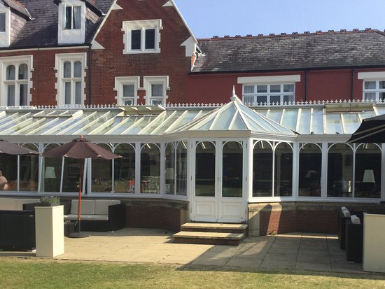 Sun-drenched conservatory at St. Anne's Manor for networking receptions and garden dining events.
