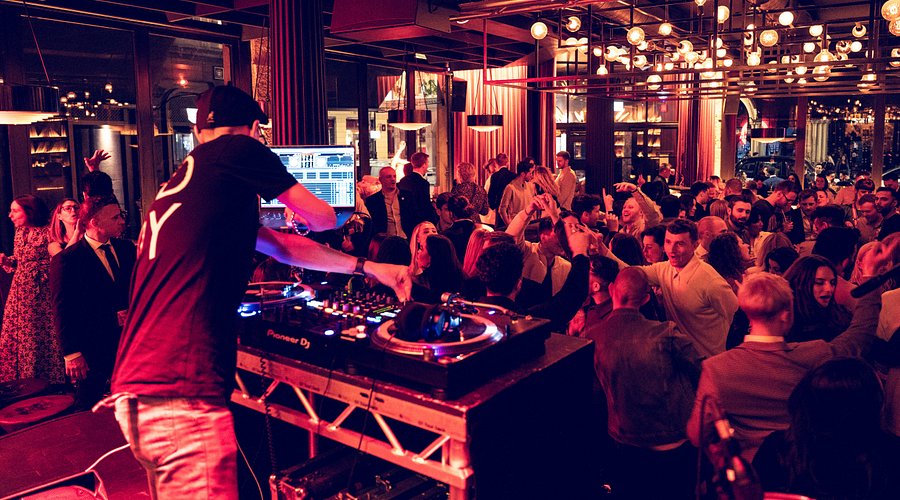DJ engaging vibrant crowd at Eastcheap Records' green room for a live event.