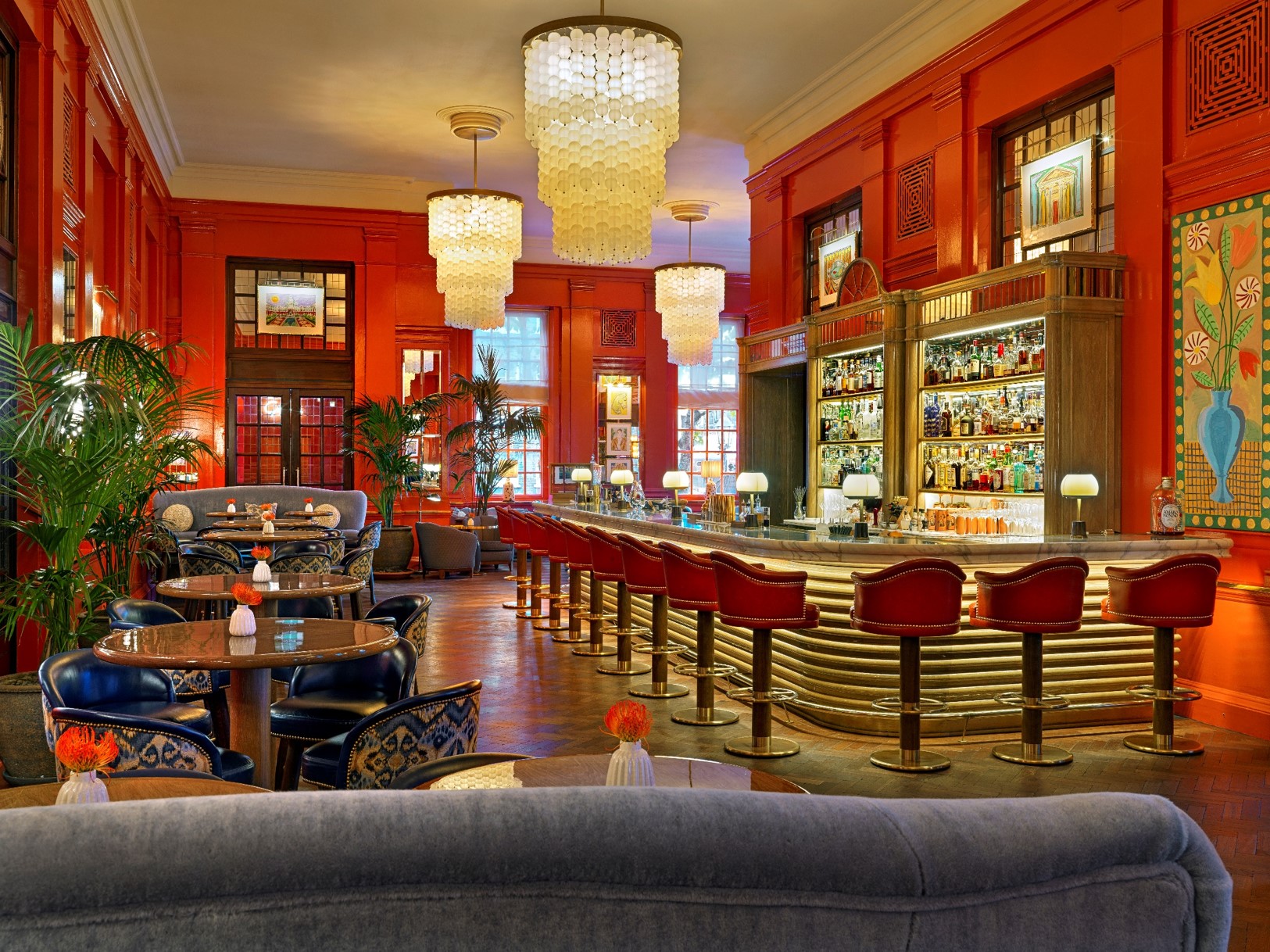 Upscale Coral Room bar with vibrant red walls, ideal for cocktail receptions and networking.