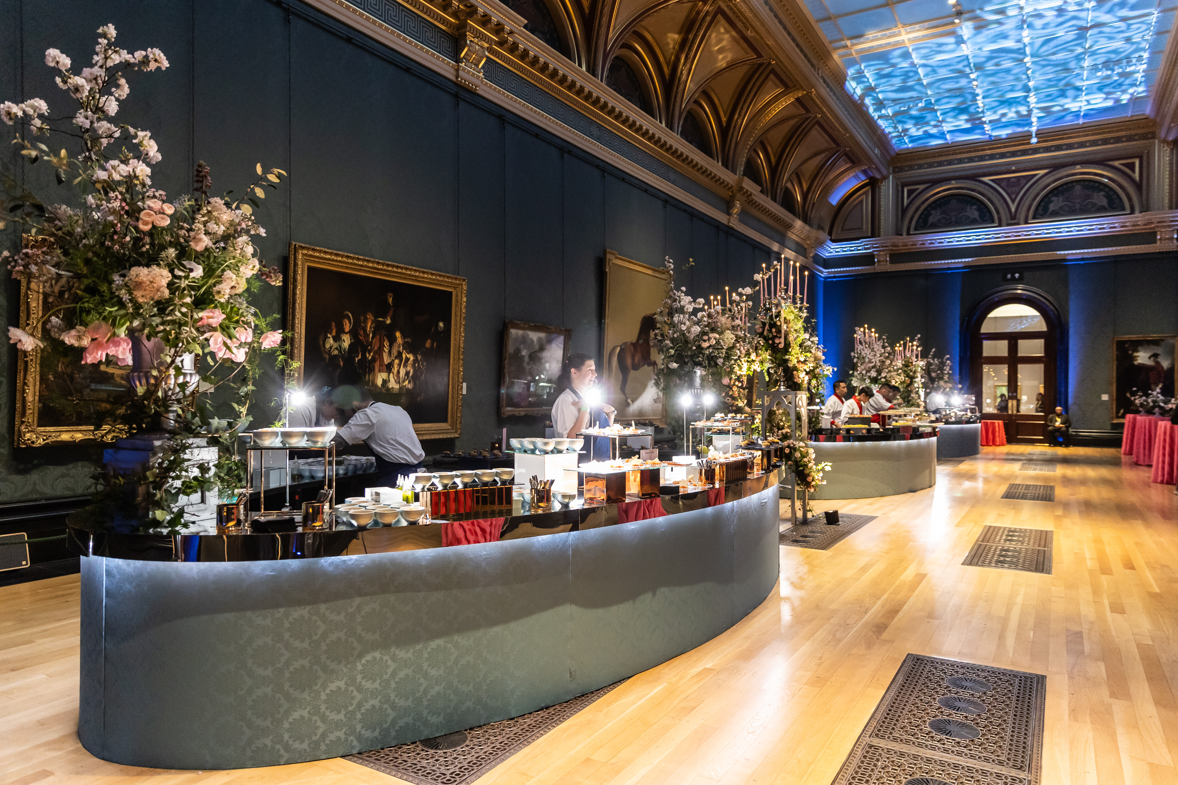 Elegant event space in National Gallery with floral buffet tables for corporate functions.