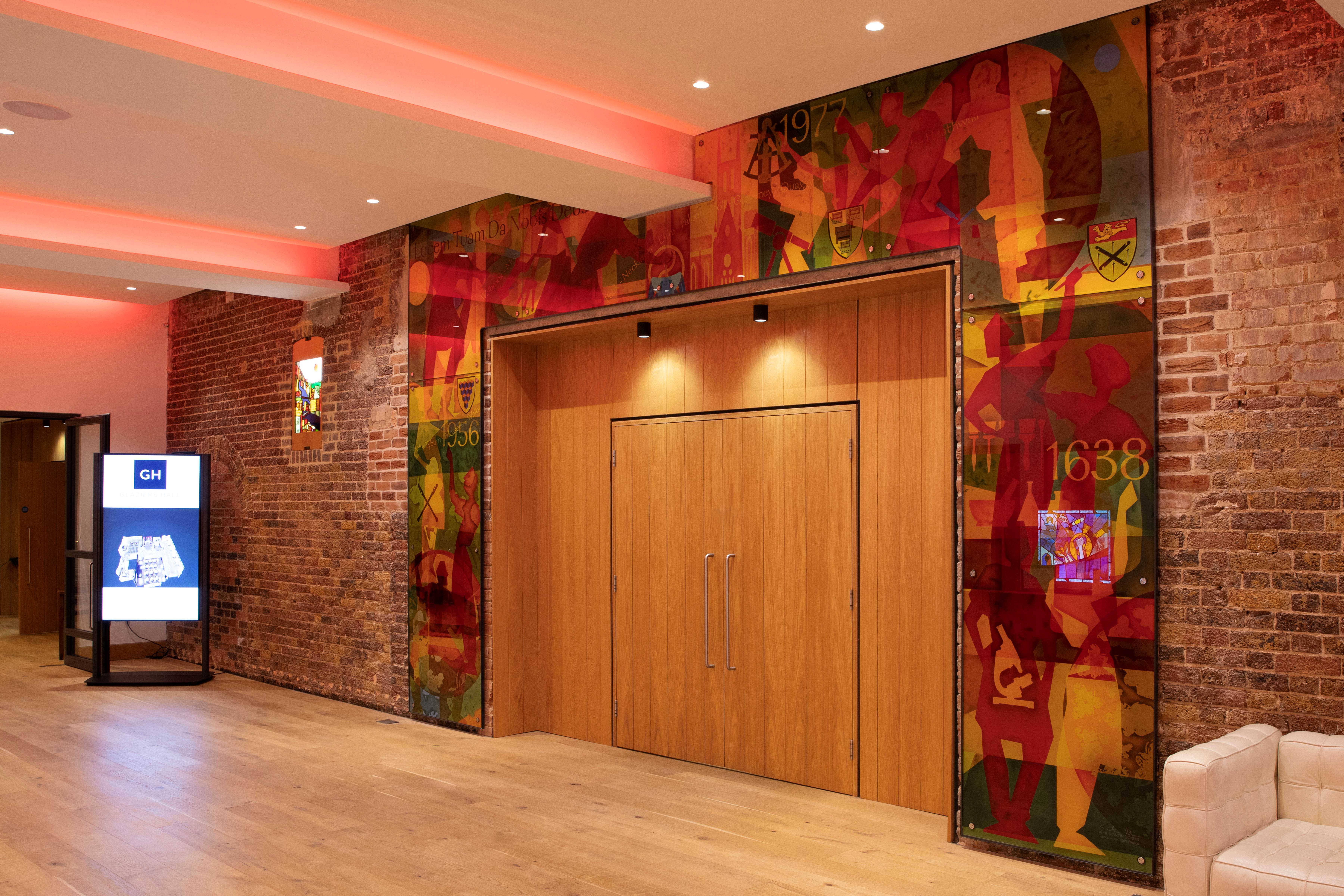 "Banqueting Hall in Glaziers Hall: modern event space with exposed brick, perfect for gatherings"