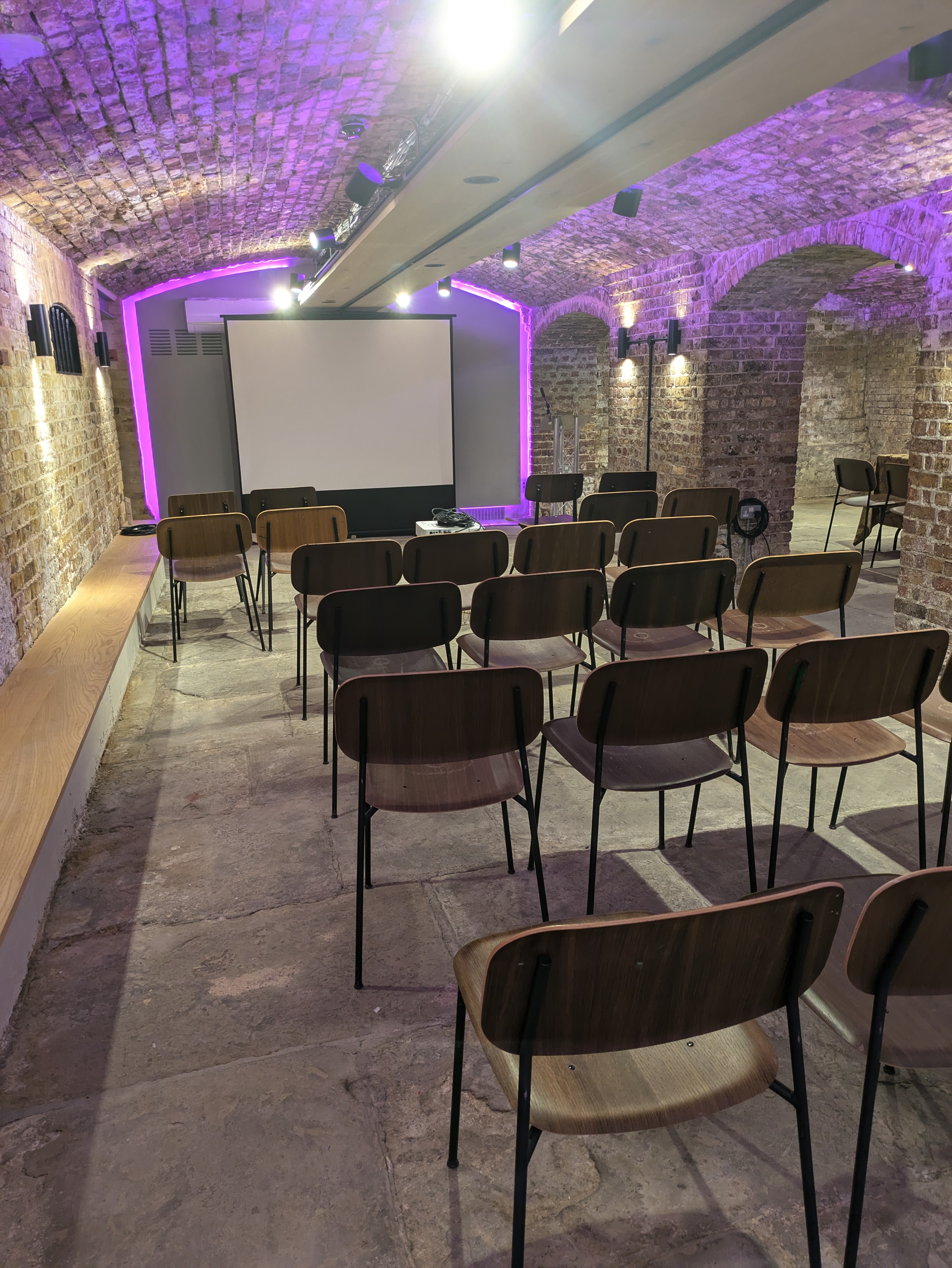 Exclusive venue hire at Glaziers Hall, featuring a projection screen and urban decor.