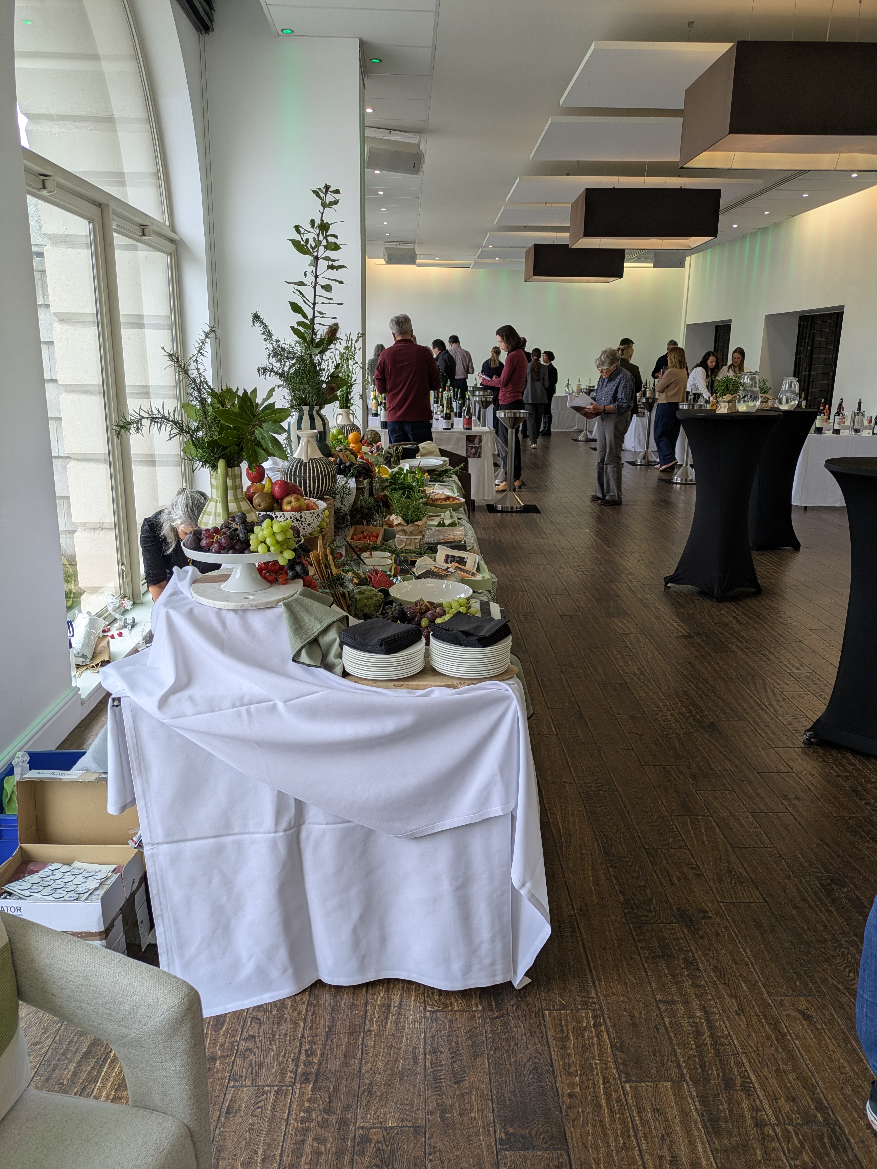 Buffet setup at Glaziers Hall for networking event, featuring fresh fruits and cheeses.