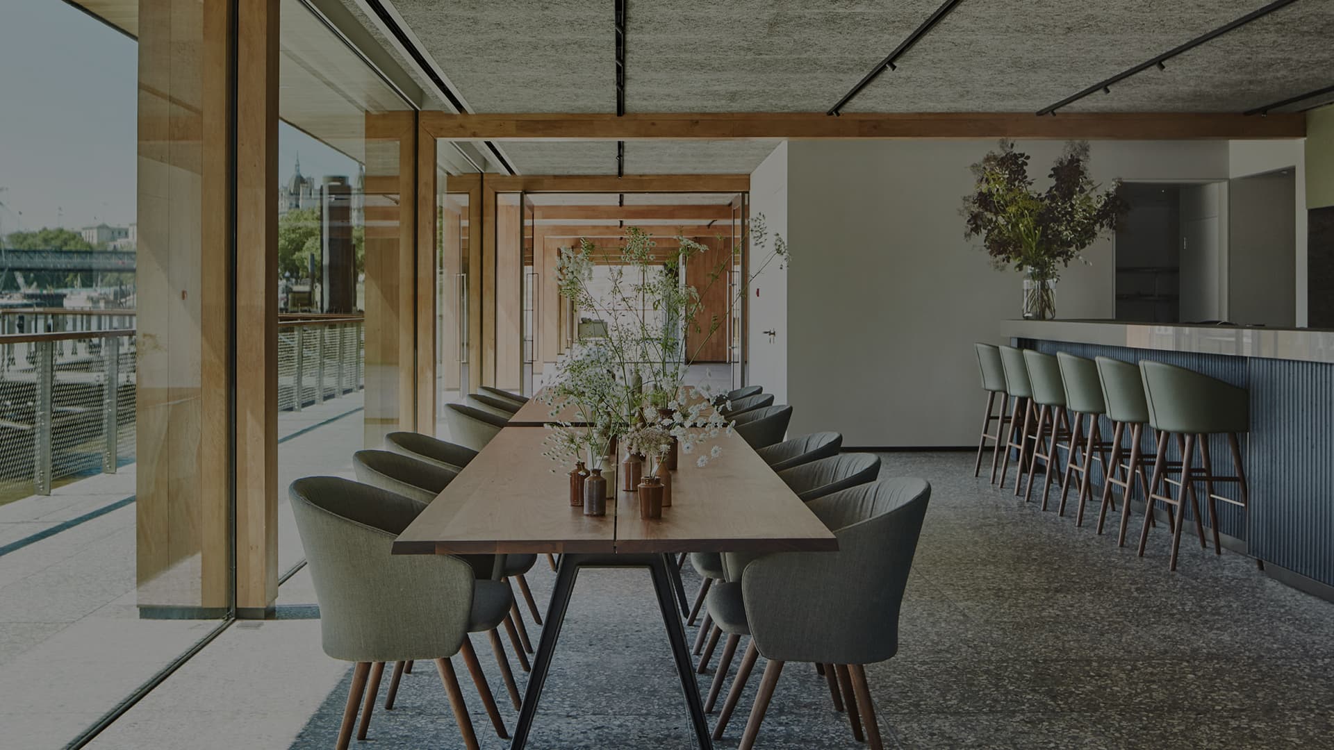 Sleek event space in Woods Quay with a long wooden table, perfect for corporate gatherings.