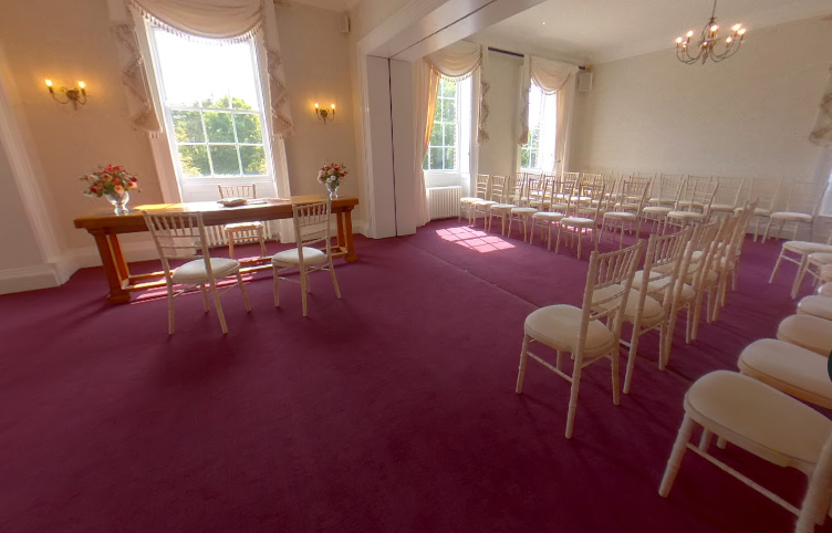 Wedding ceremony setup in Ewart Room, Morden Park House with magenta carpet for intimate events.