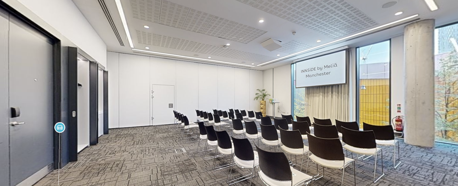 Modern meeting room with flexible seating at INNSIDE Manchester for workshops and presentations.
