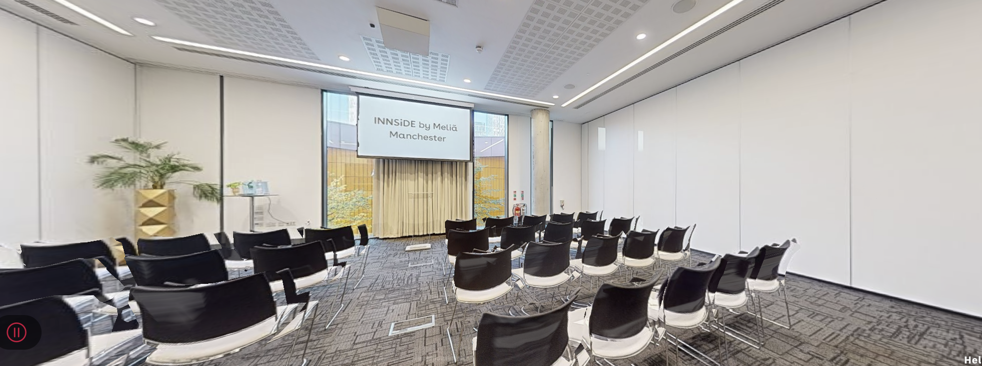 Modern conference room at INNSIDE Manchester, ideal for presentations and workshops.