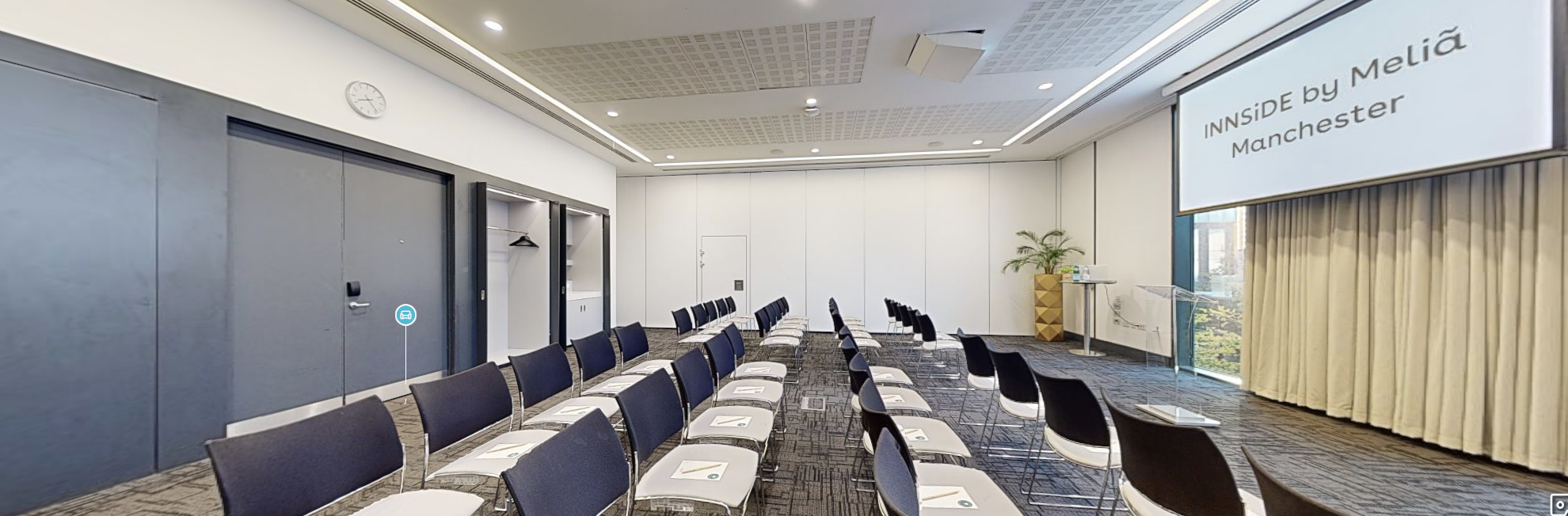Conference room with chairs and presentation area, perfect for corporate meetings in Manchester.