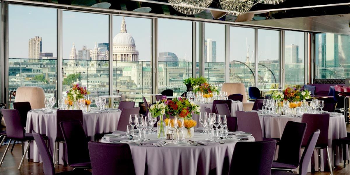 Elegant event space at 12th Knot, featuring floral decor and city skyline views.