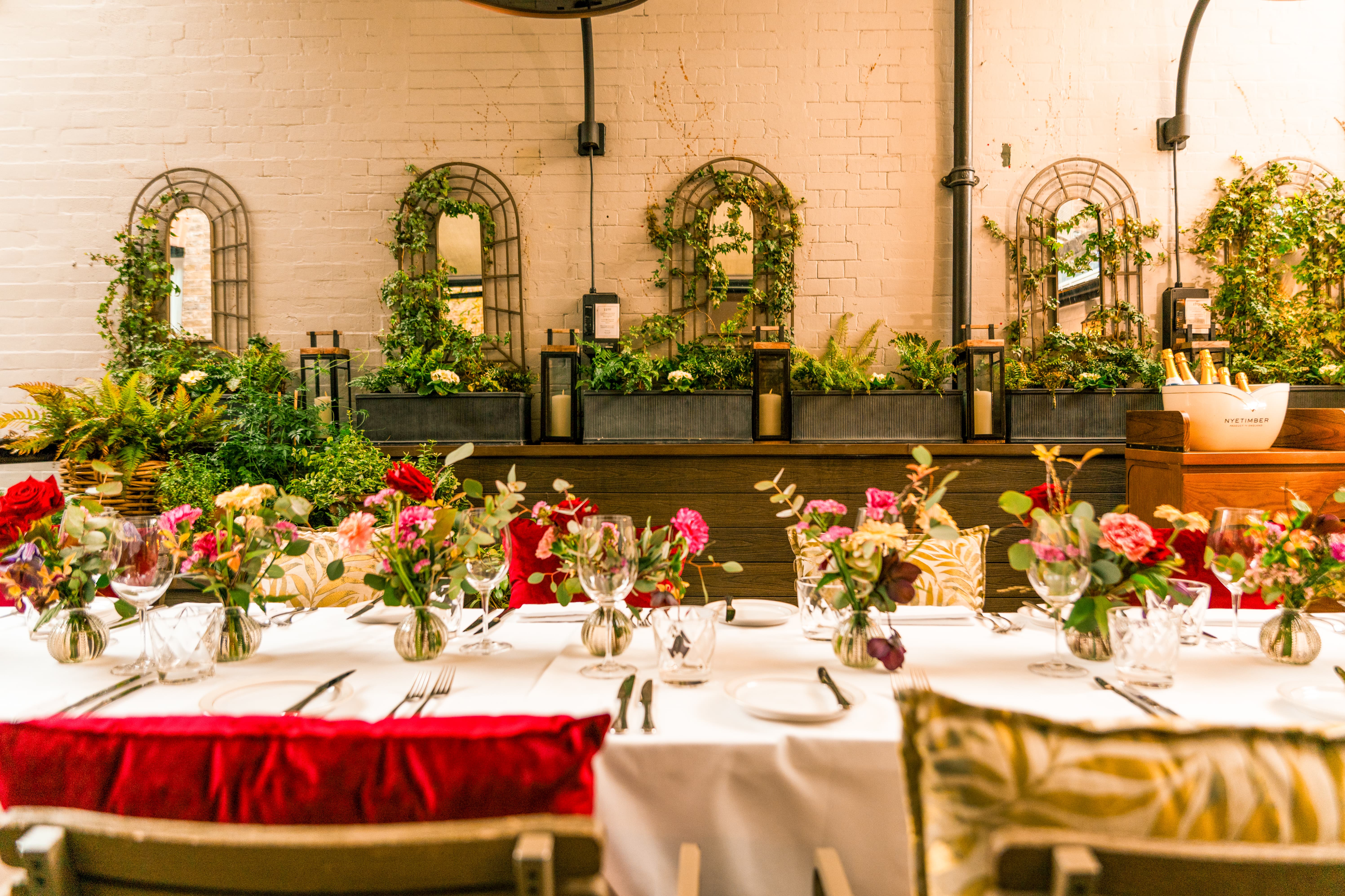 The Secret Garden boutique event space with lush greenery for intimate dining and networking.