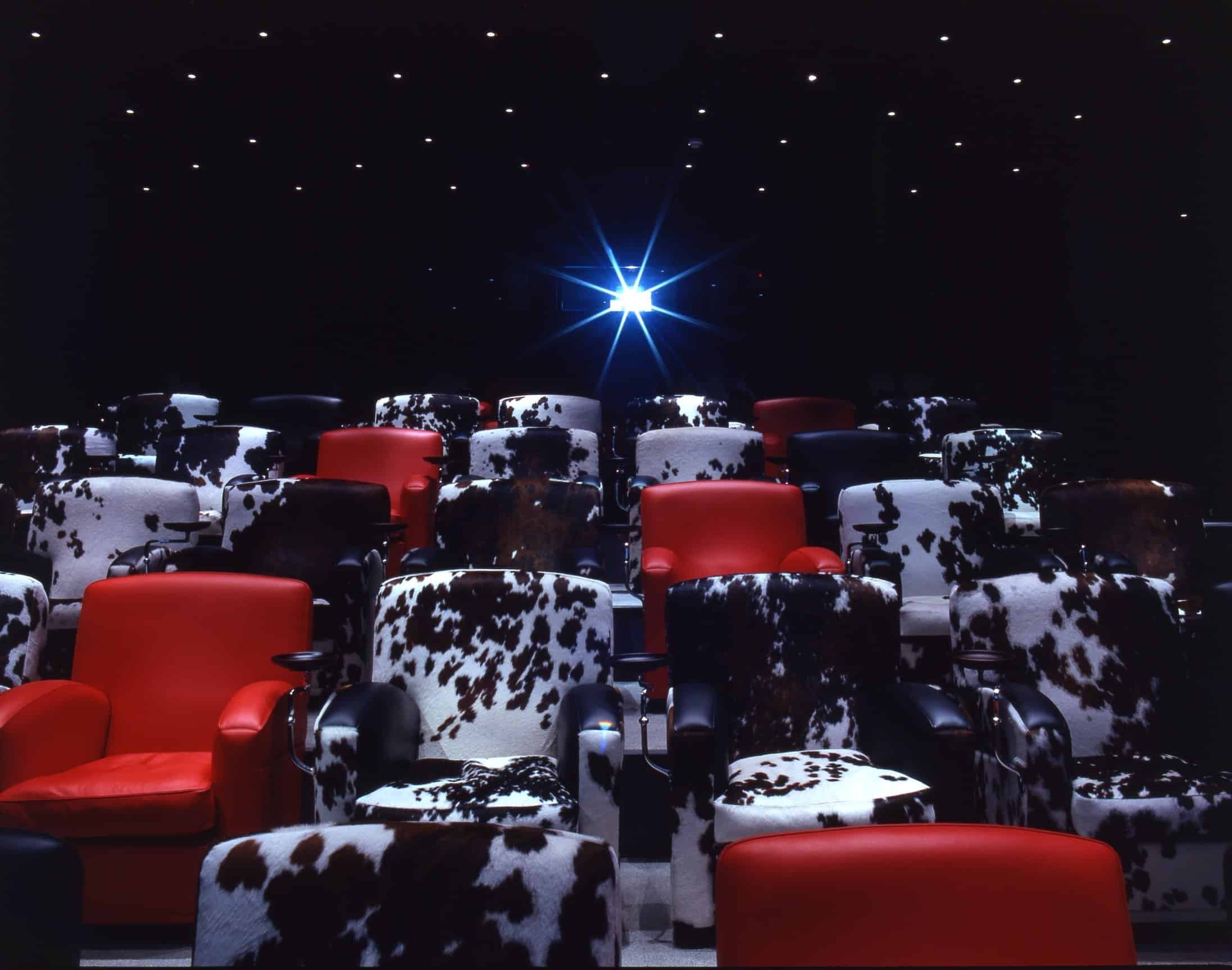 Covent Garden Hotel screening room with red cow-patterned chairs for engaging events.