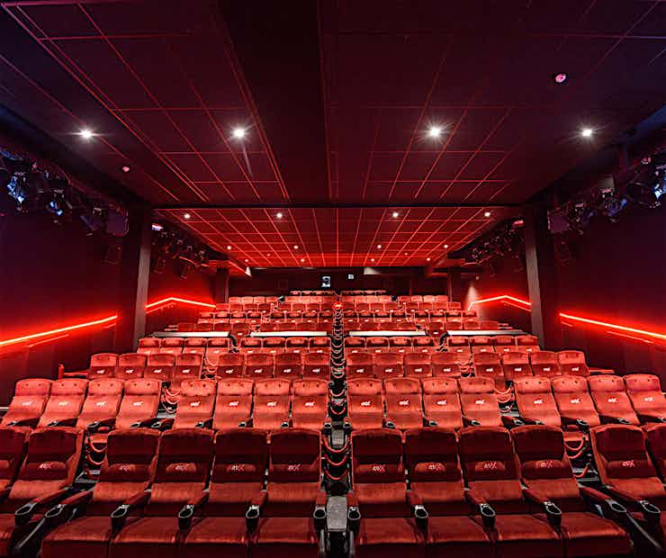 Modern screening room with tiered red seating for events and presentations at Covent Garden Hotel.