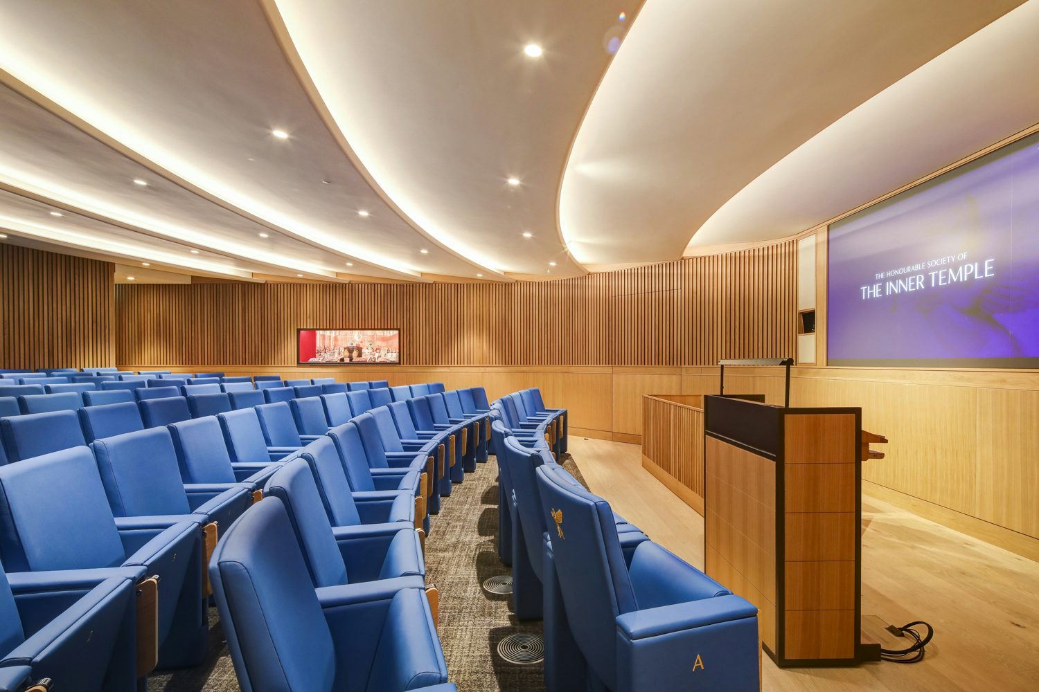 Modern lecture theatre with blue seating for meetings and presentations at Inner Temple.