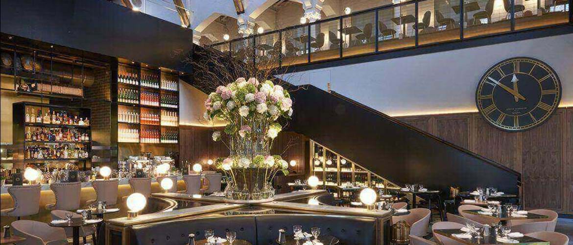 Elegant dining space at Meister Bar, perfect for upscale events with floral centerpiece.