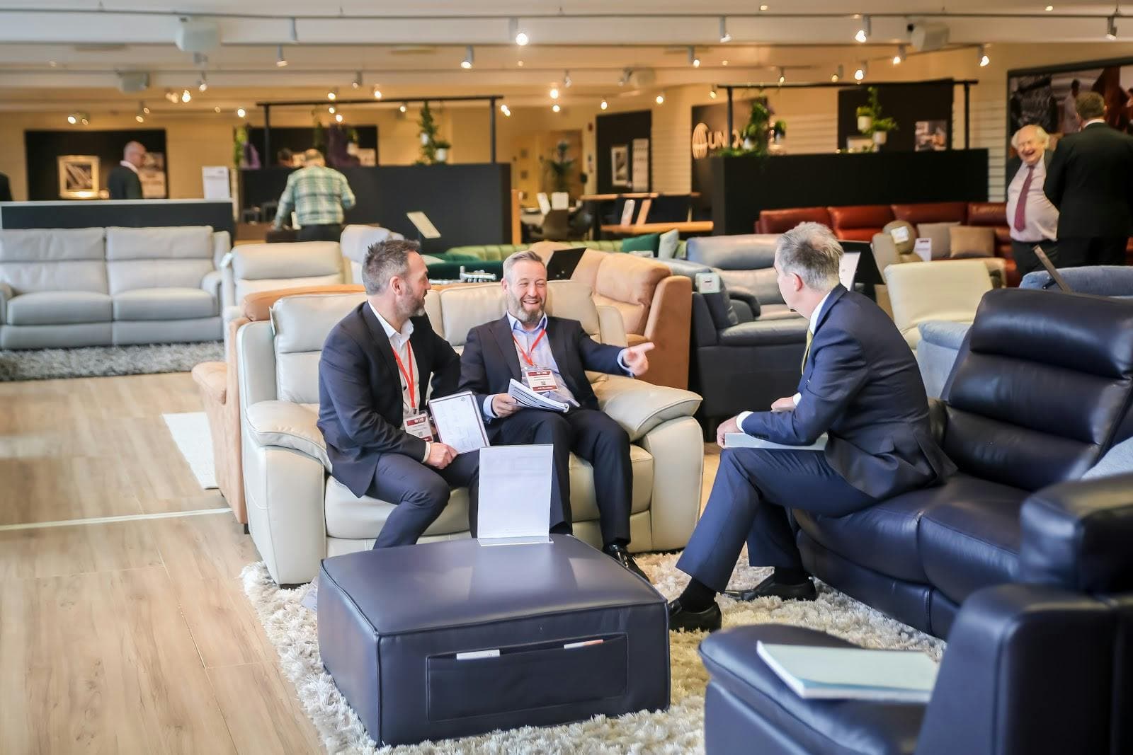 Small-group business breakout clusters at Cranmore Park furniture showroom venue.