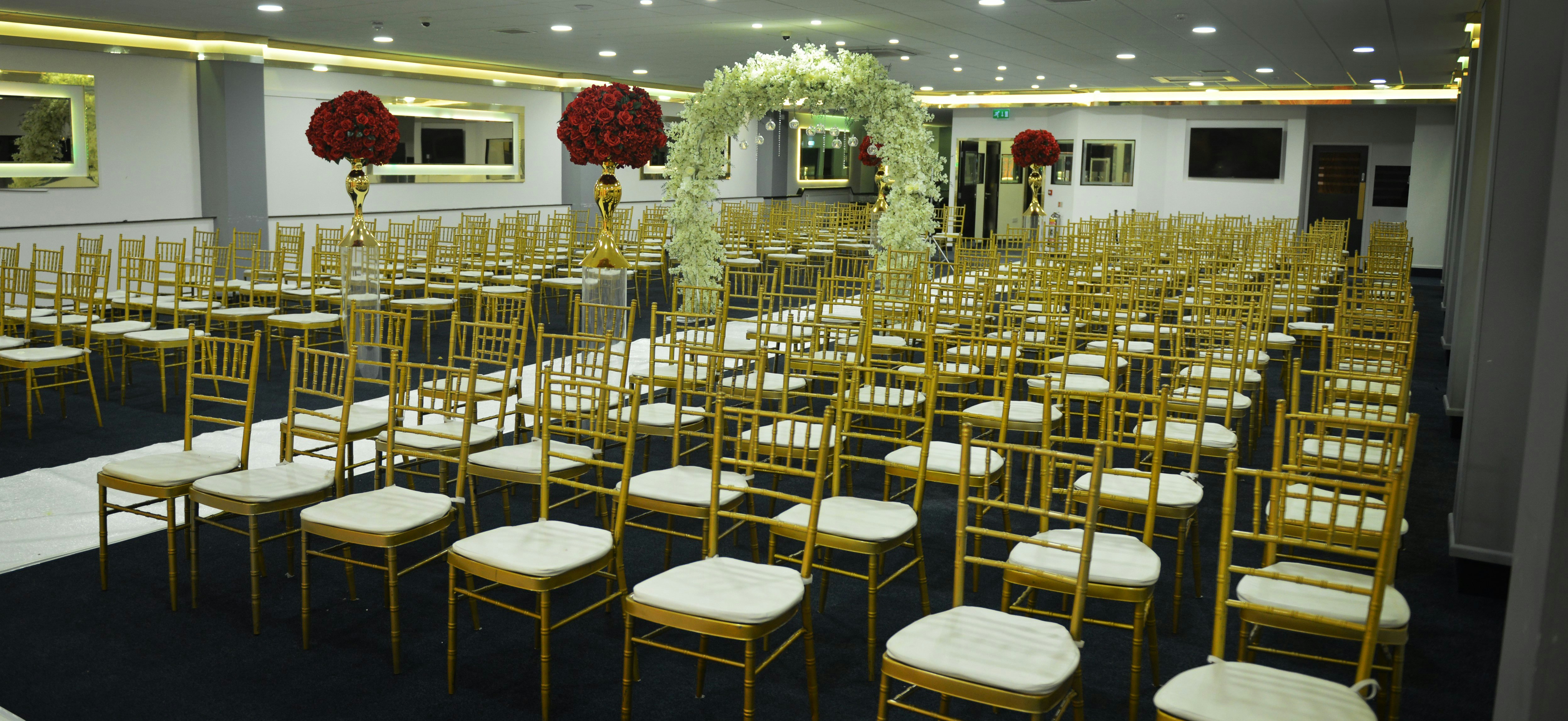 The Gulshan Suite: Elegant gold Chiavari chair ceremony setup for wedding and event hosting.