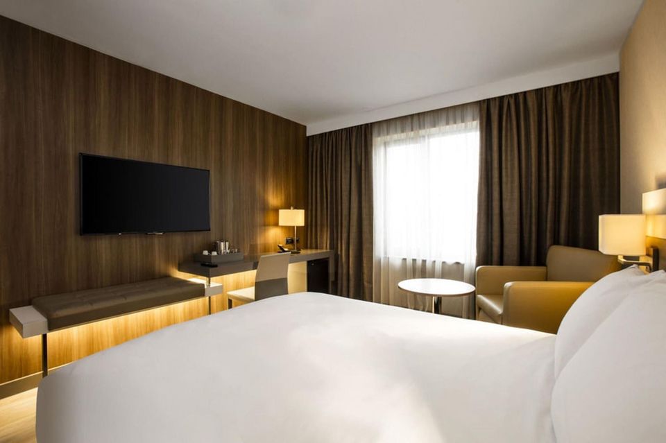 Modern hotel suite with workspace for business travel and remote work connectivity.