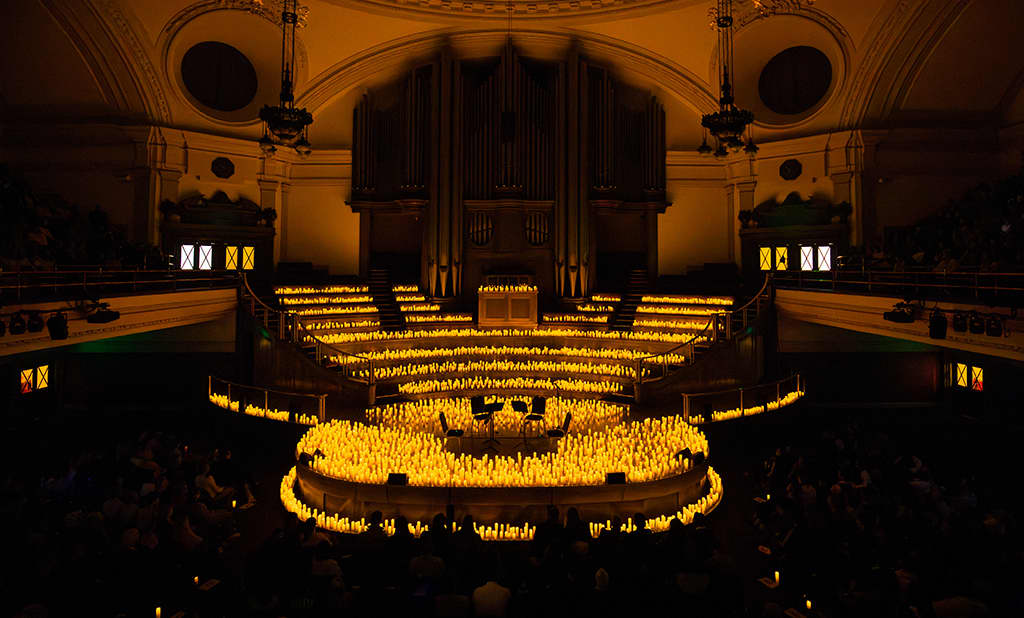 Auditorium in Central Hall Westminster set for an elegant concert with candlelit warmth.
