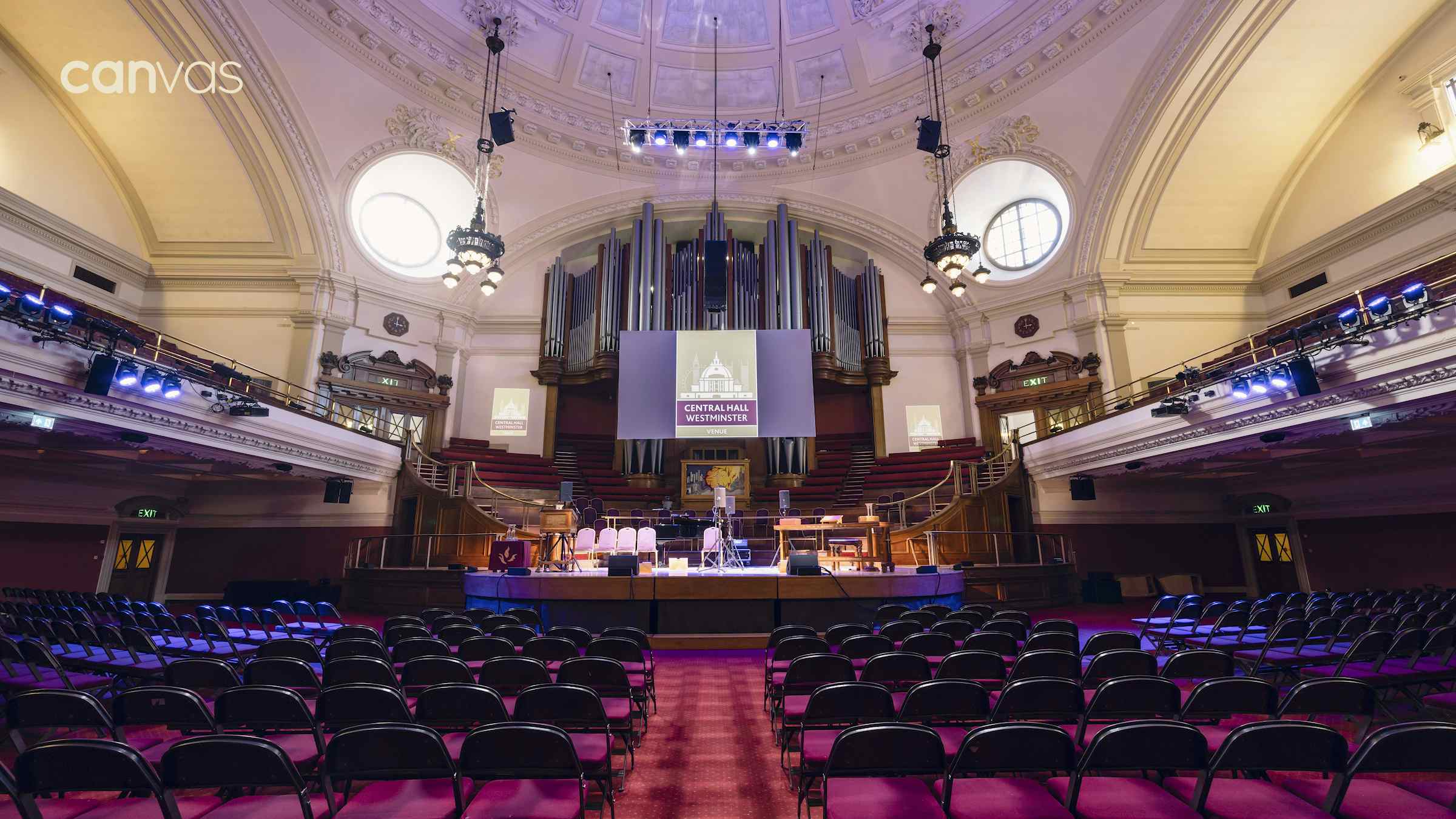 Central Hall Westminster auditorium set for a conference with elegant architecture and sound equipment.