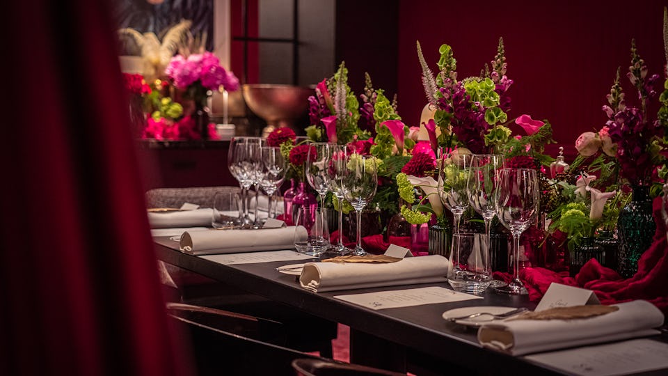 Elegant private dining table with floral arrangements for corporate gatherings and celebrations.