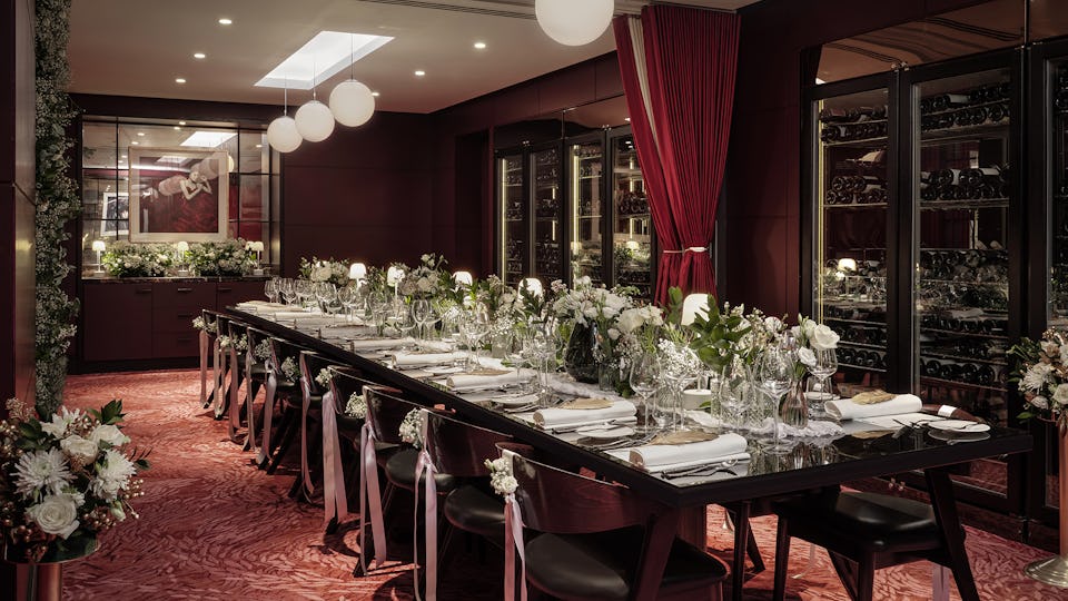 Elegant private dining table set for formal events with floral arrangements at The Pem.