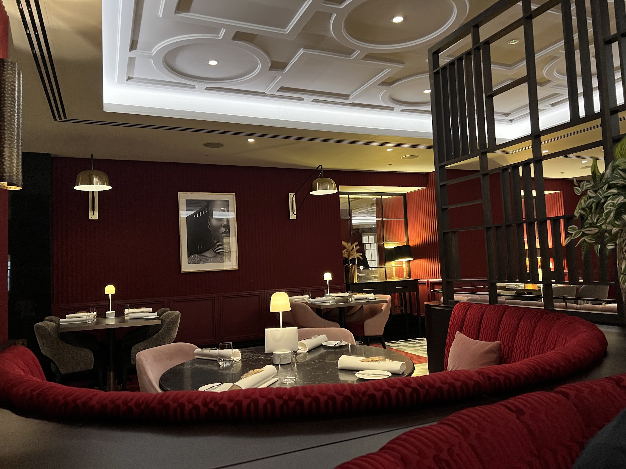 Elegant restaurant dining space with rich red tones for corporate events and gatherings.