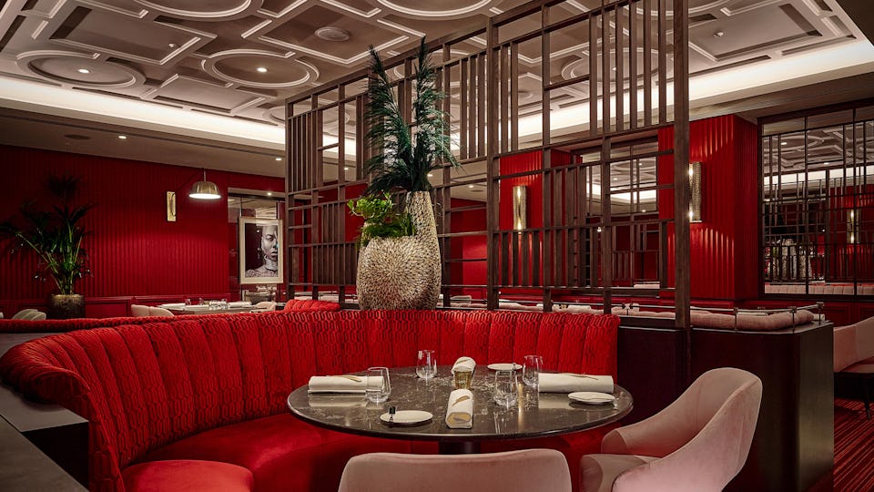 Stylish bar with rich red tones, perfect for intimate gatherings and upscale events.