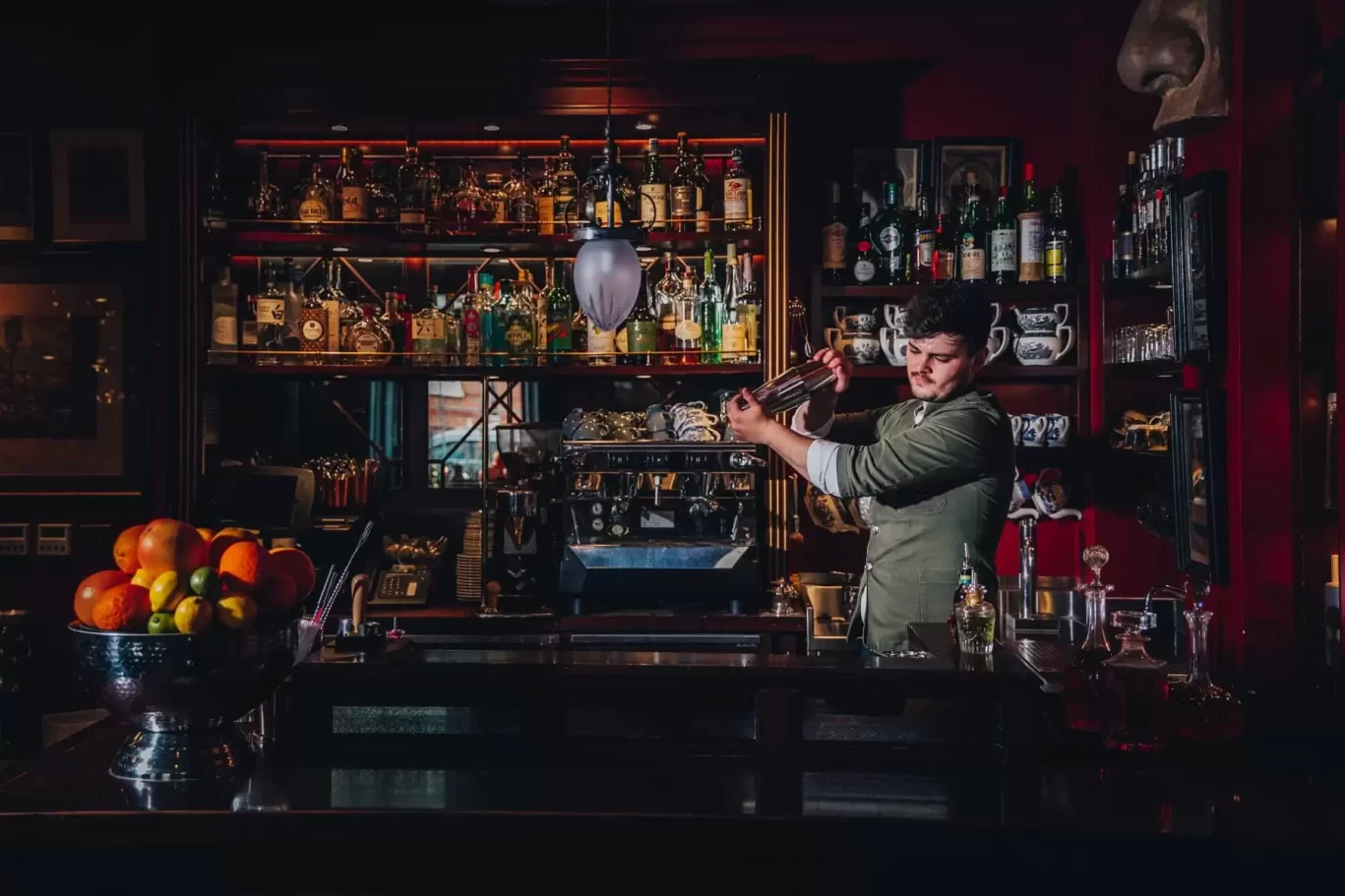Skilled bartender mixes drinks at The Zetter Marylebone cocktail bar for events.