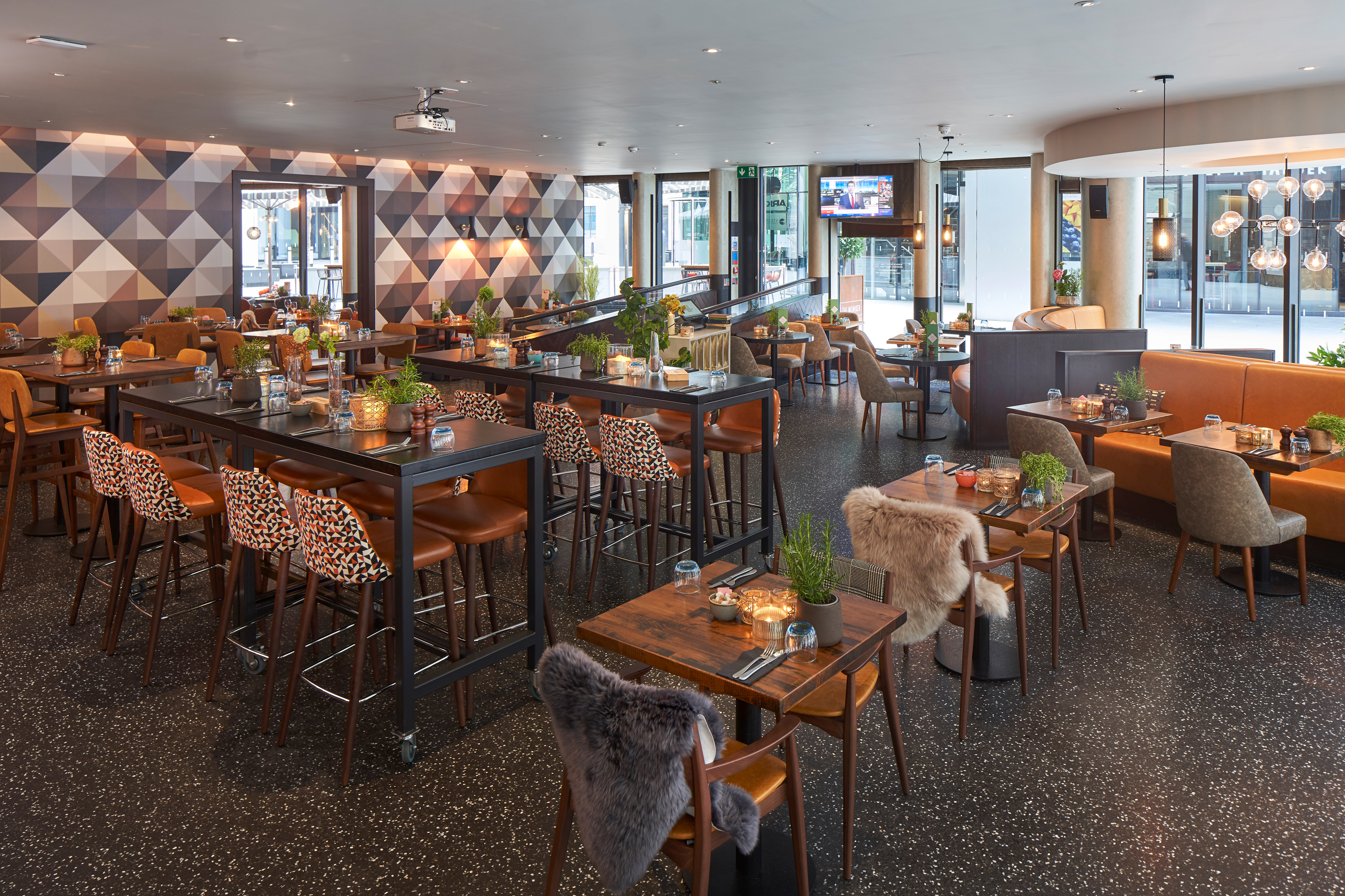 Modern event space at The Moniker with high-top tables for corporate networking and mixers.