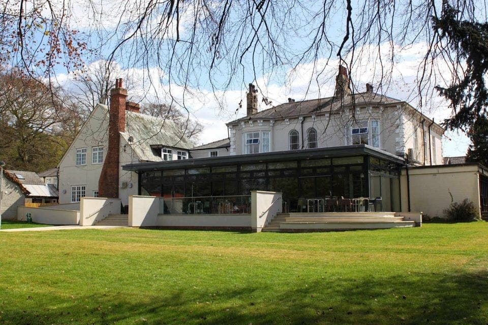 YHA York meeting room with glass-enclosed space for corporate retreats and outdoor events.