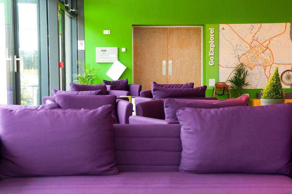 YHA York meeting room with vibrant lounge seating for networking and breakout sessions.