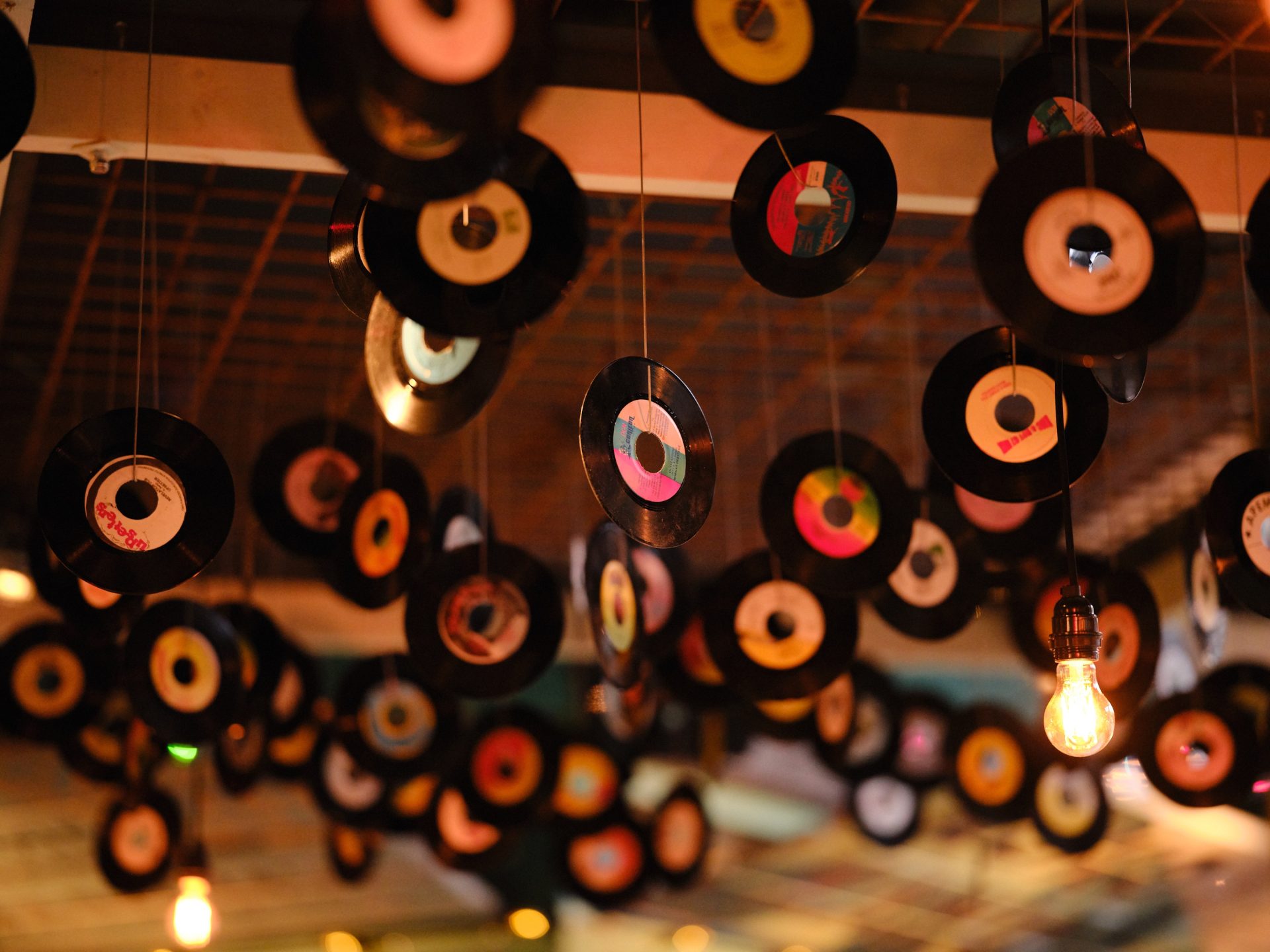 Private upstairs seating area with vibrant decor and vinyl records for music events.