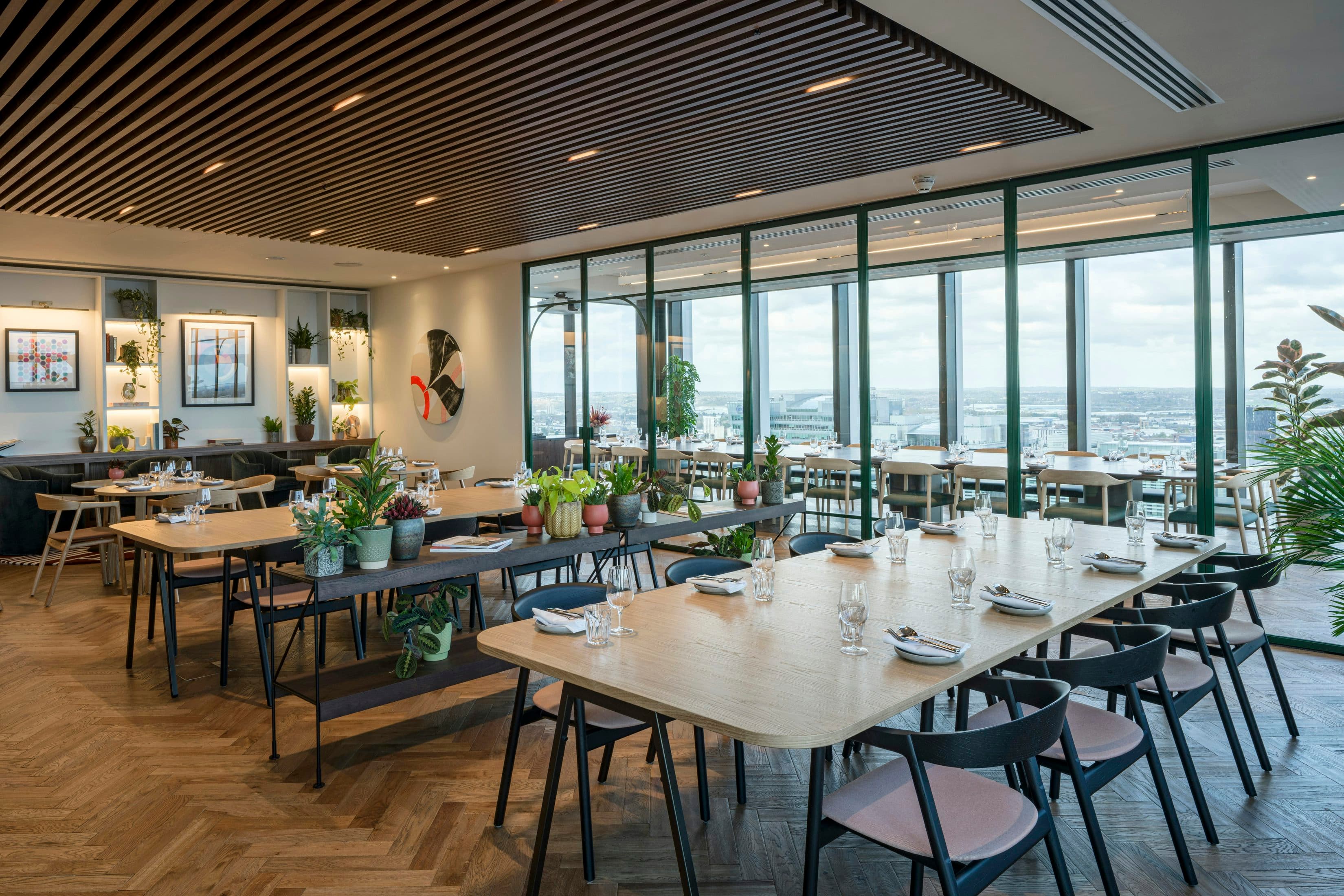 Modern corporate business lounge with floor-to-ceiling windows for networking and workshops.