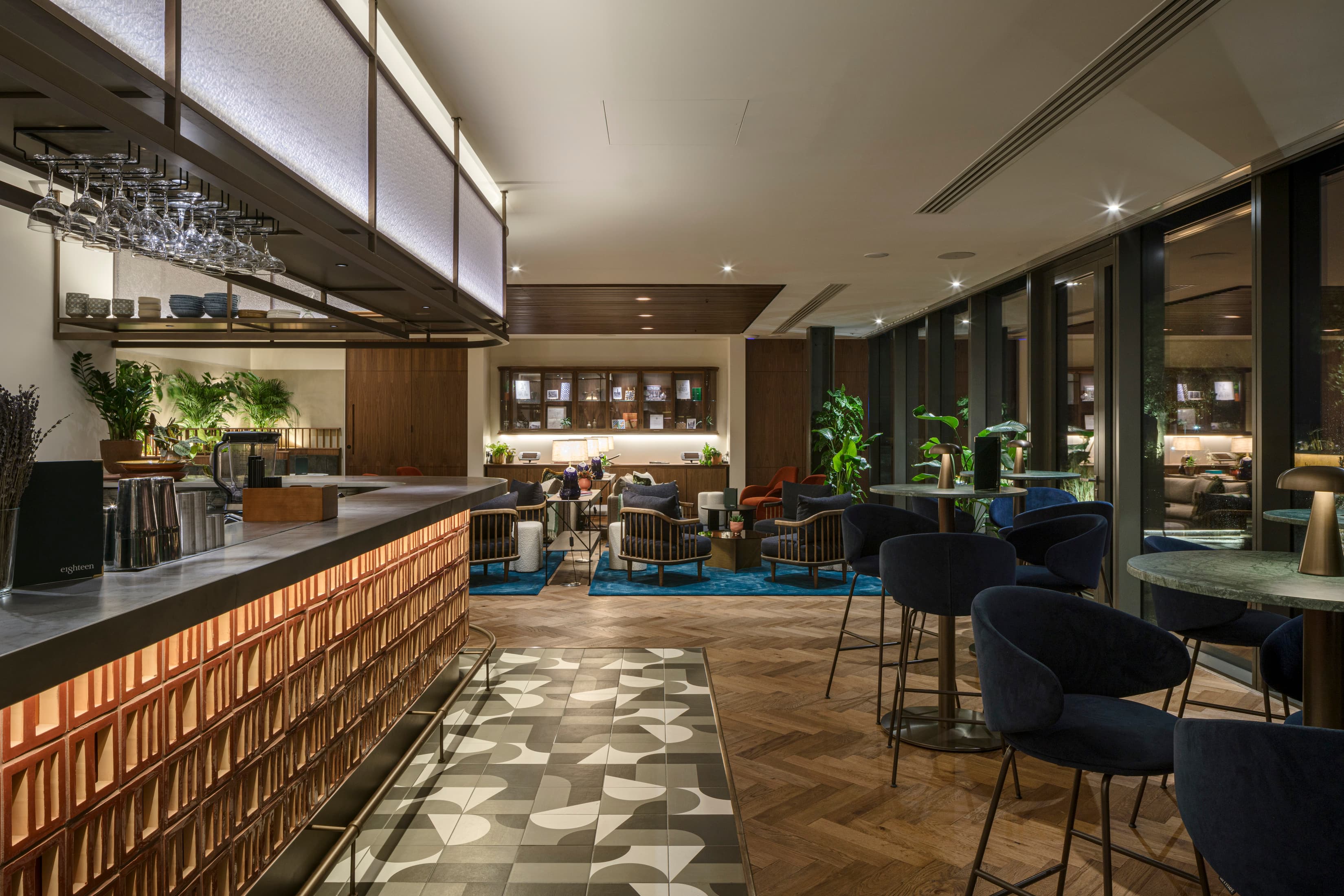 Corporate reception lounge with bar and seating for networking events.
