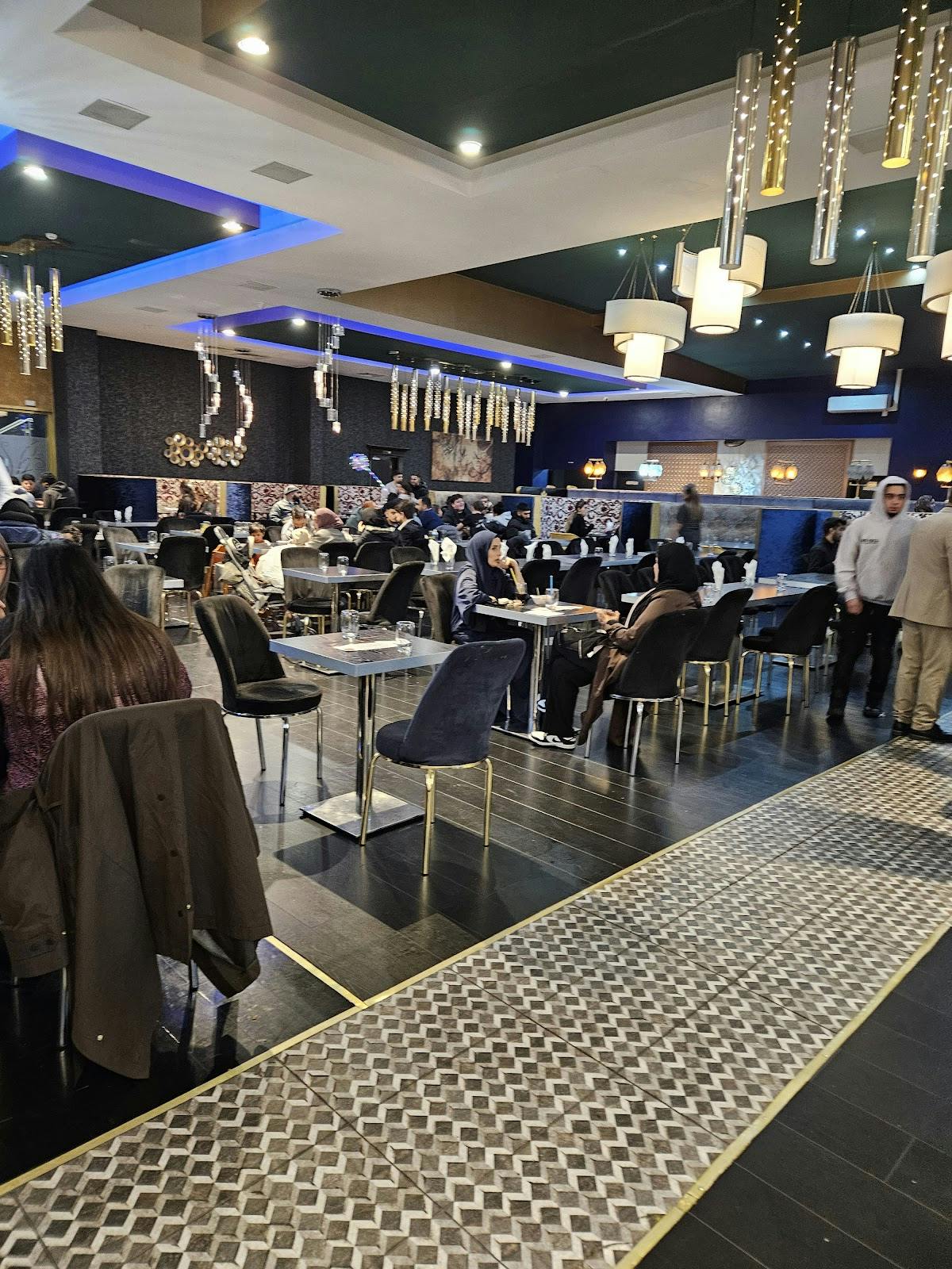 Royal Shalimar banquet hall with modern tiered chandeliers for networking and social events.