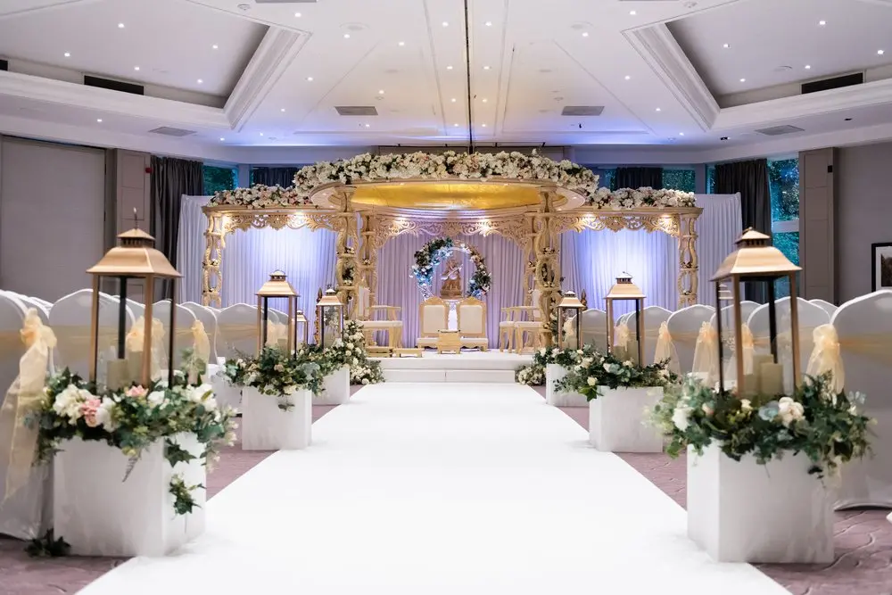Woodlands Suite at The Belfry: elegant wedding ceremony space with floral arch and lanterns.