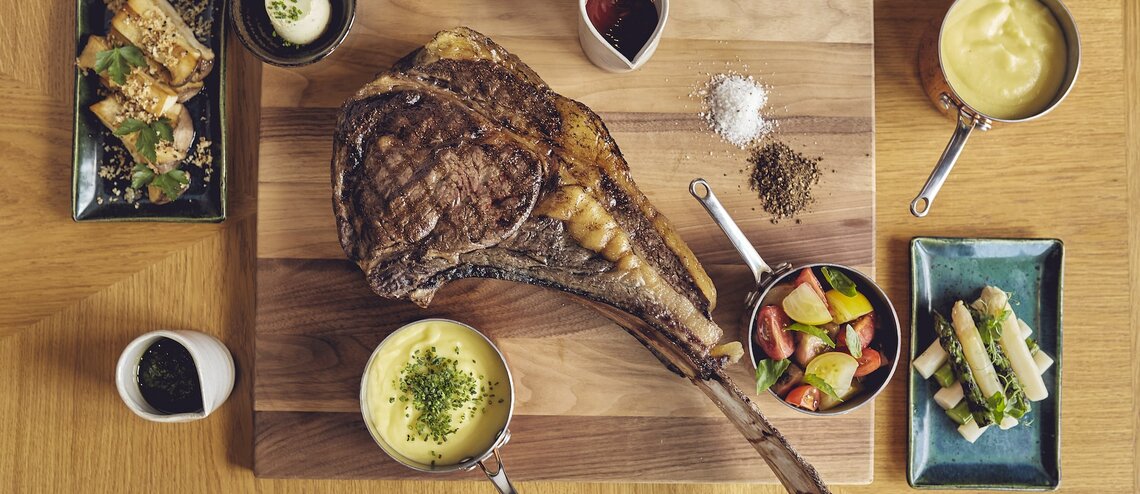 Rustic-chic LOUIS Grillroom dining table for executive retreat or VIP dinner.